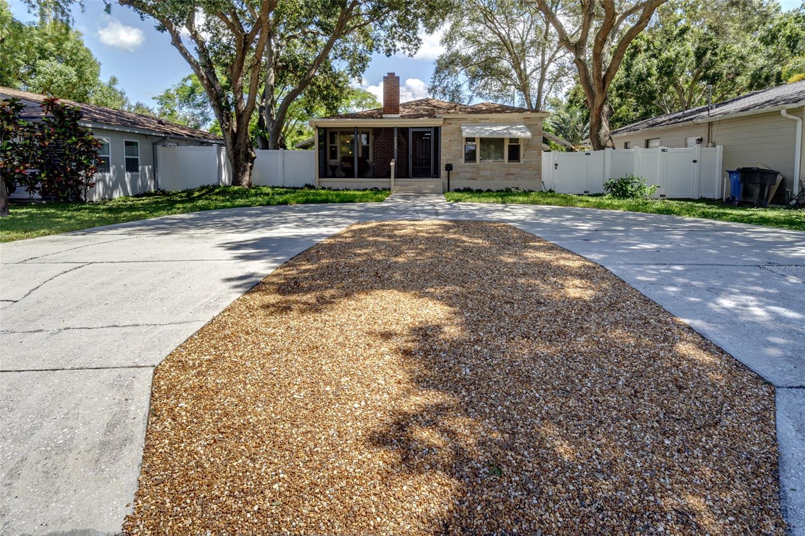 Front view of home from street....house set back under huge oak trees and offers a semi-circular driveway for parking convenience