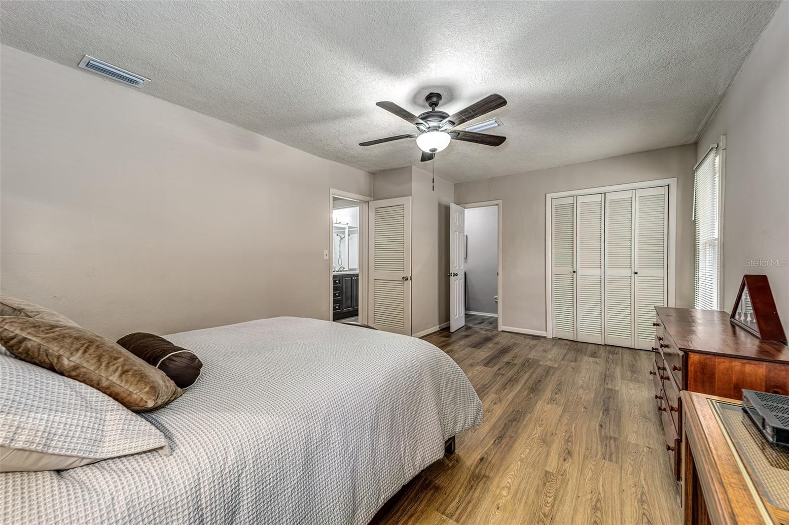 Primary bedroom, other view...dual closets and private half-bath