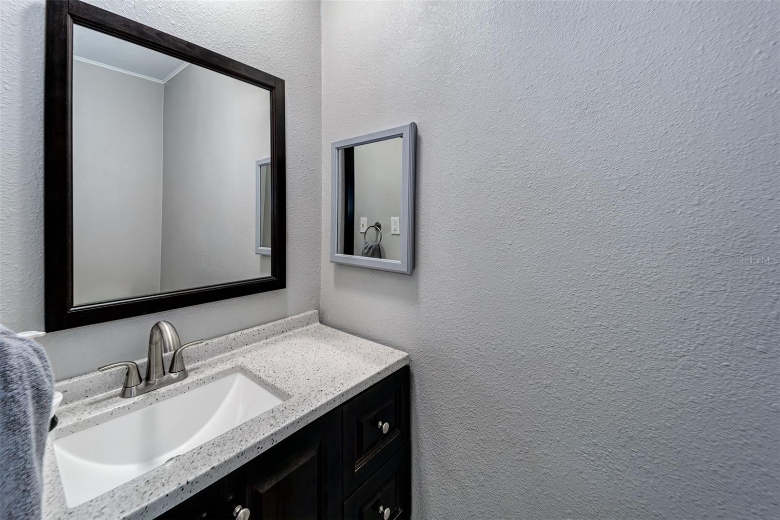 Private half-bath in primary bedroom suite