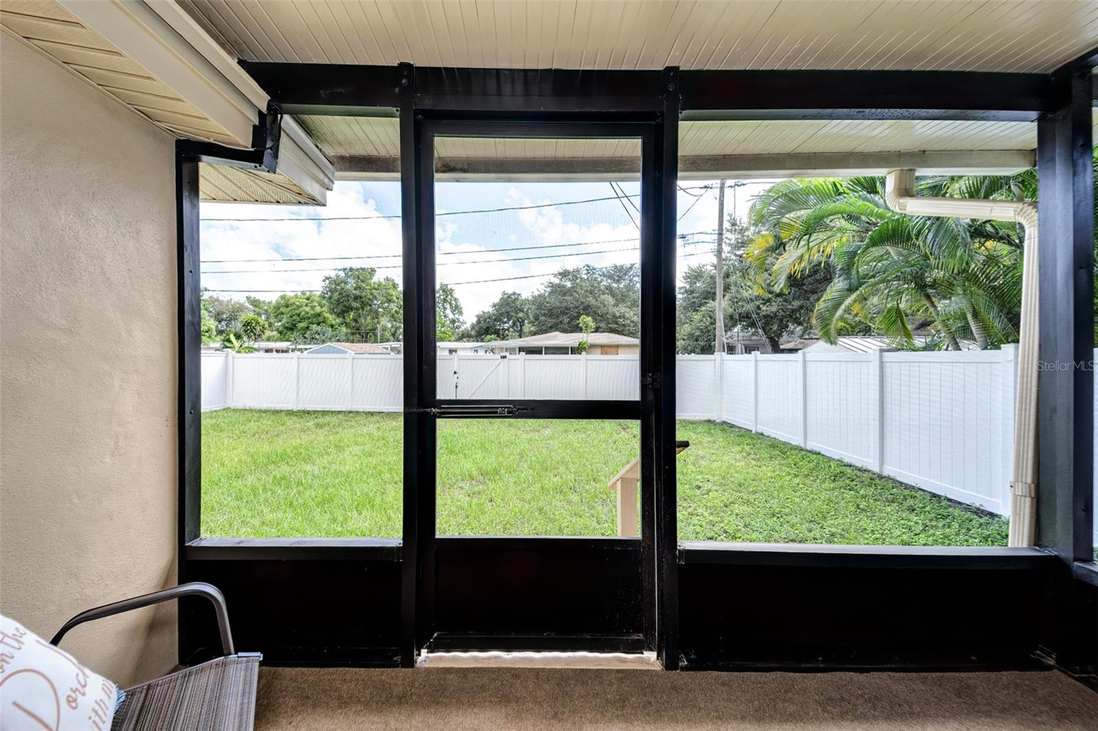 View from rear porch to private, fully fenced back yard