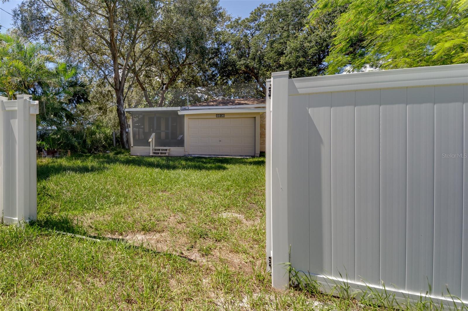 Large gate in rear of vinyl gate along alley provides additional access for boat or RV!