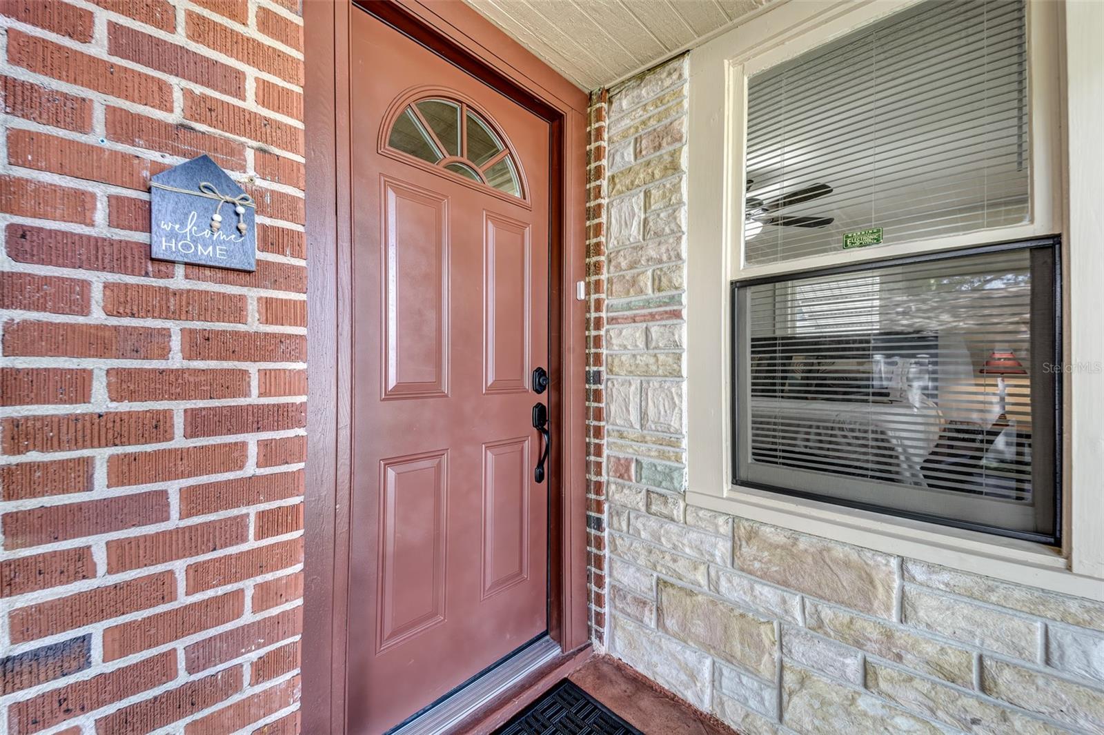 Front entry door and window to second bedroom