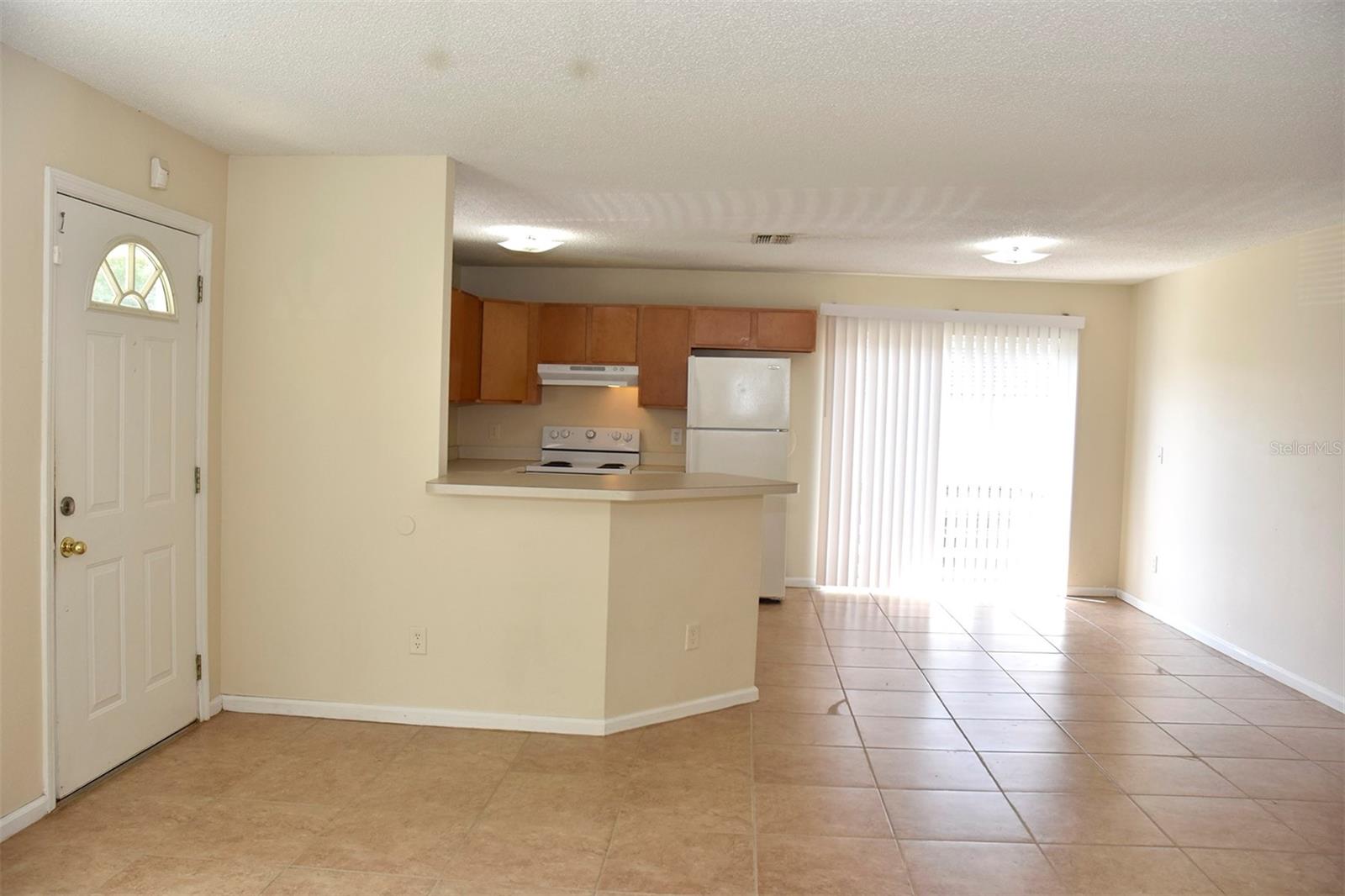 Open and inviting floor plan with lots of natural light and ceramic tile floors throughout the home.