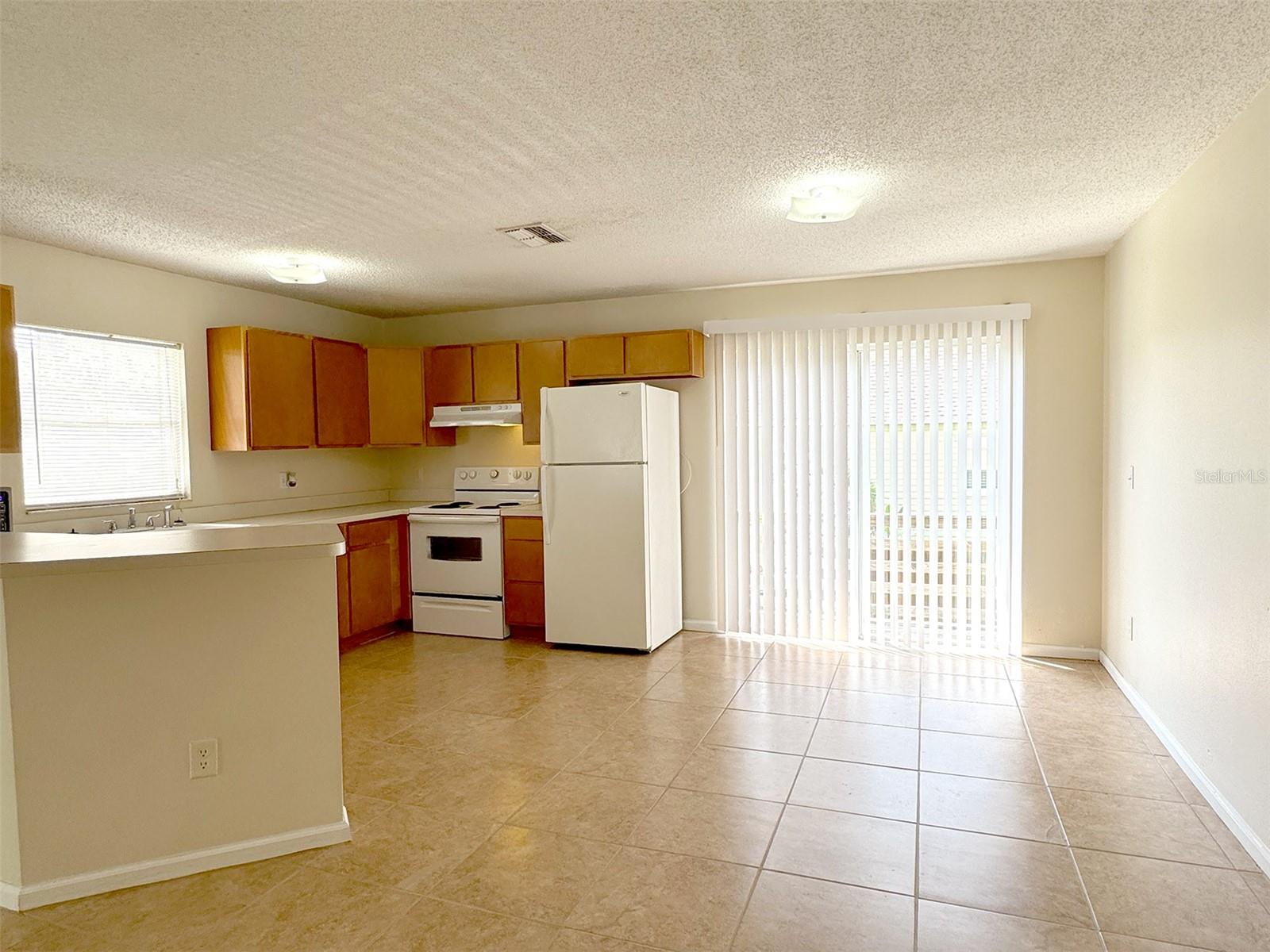 Dining area has sliders to the deck and stairs down to the yard.