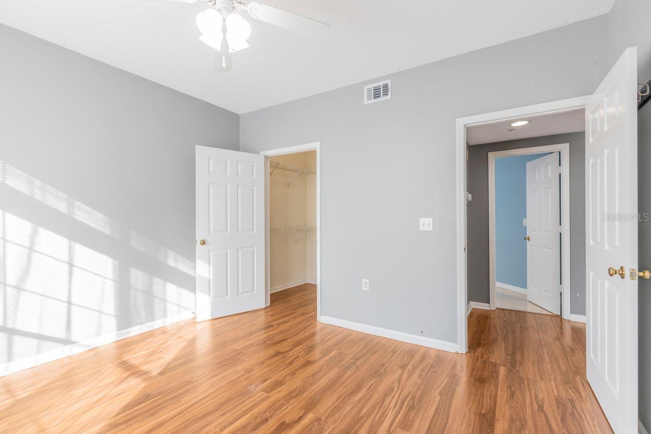 Primary bedroom with built-in shelving and walk-in closet