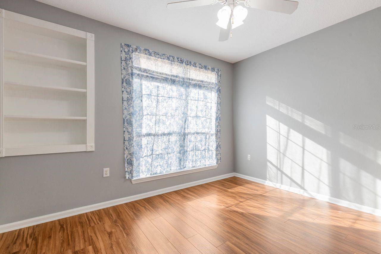 Primary bedroom with built-in shelving and walk-in closet