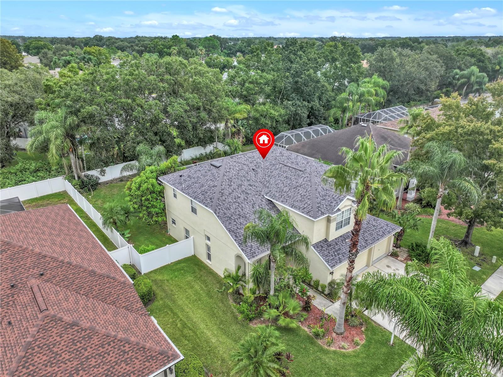 DRONE VIEW OF THE FRONT OF THE PROPERTY SHOWING NEW ROOF