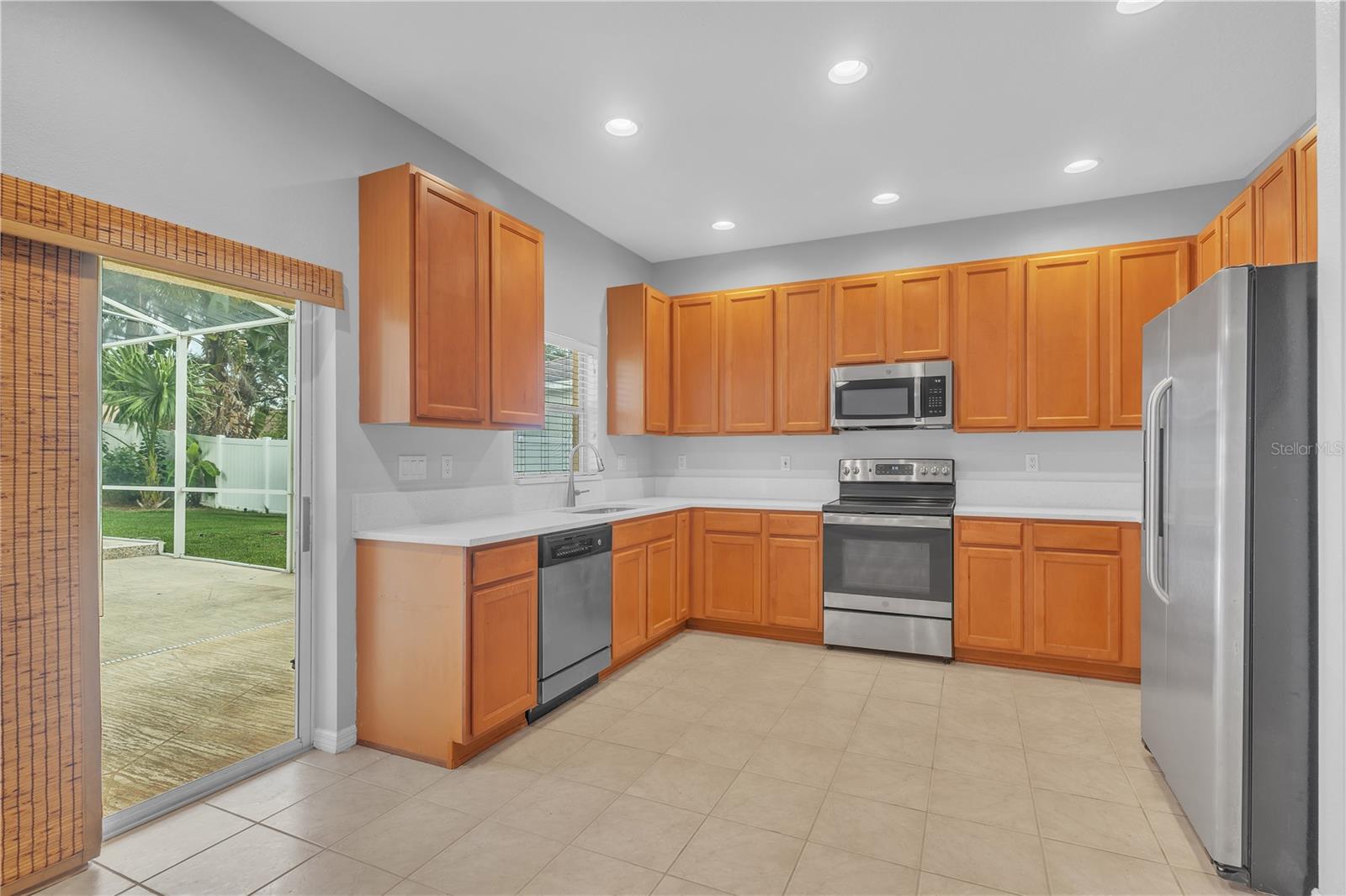 KITCHEN WITH QUARTZ COUNTER TOPS WITH SLIDERS TO LANAI