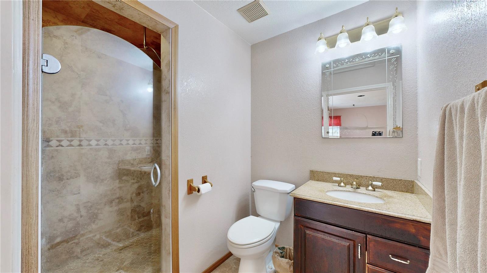 Primary suite bathroom with walk-in shower.