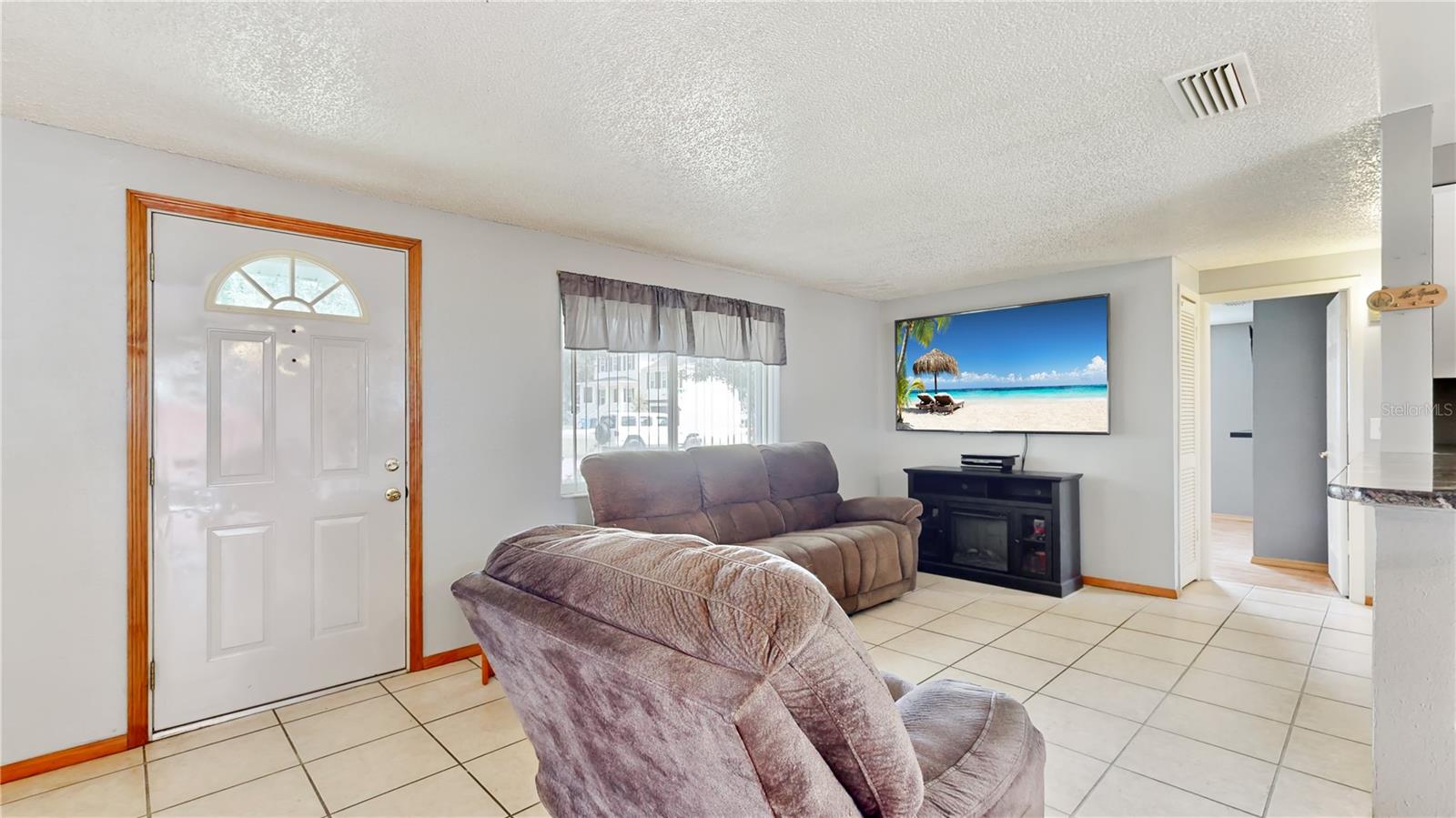 Entrance opens up to living room, dining room and kitchen.