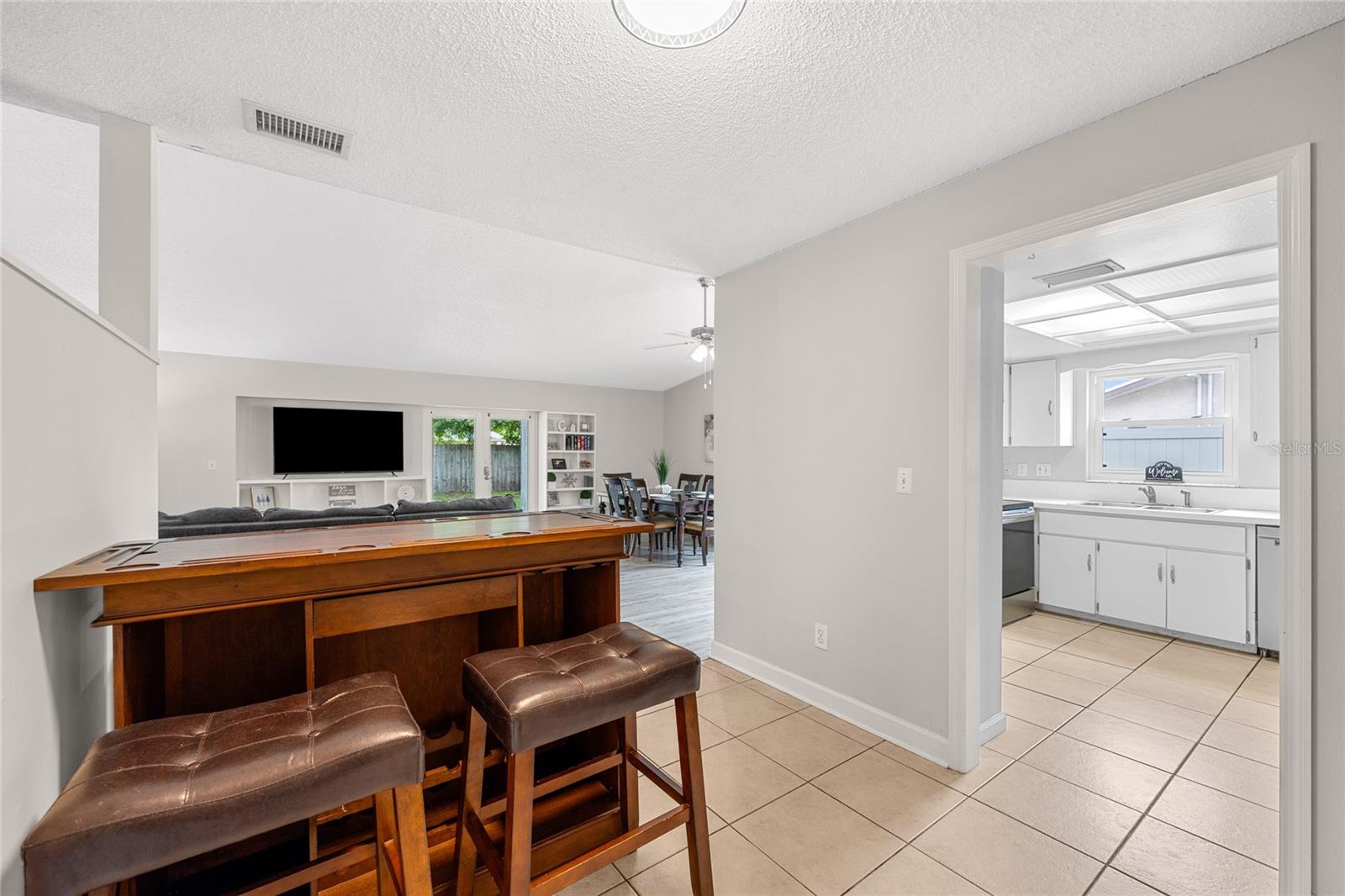 View from the bonus space showing the adjacent kitchen