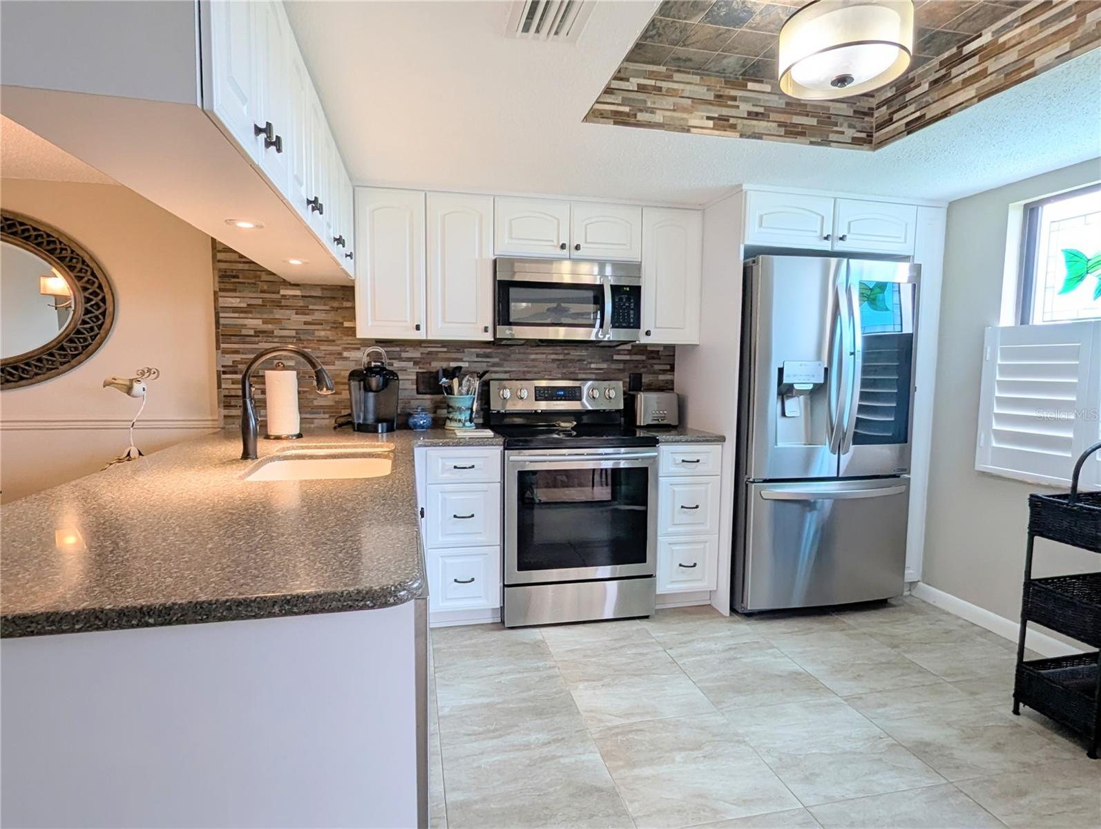 Kitchen with Tile Backsplash, Tile ceiling accents.