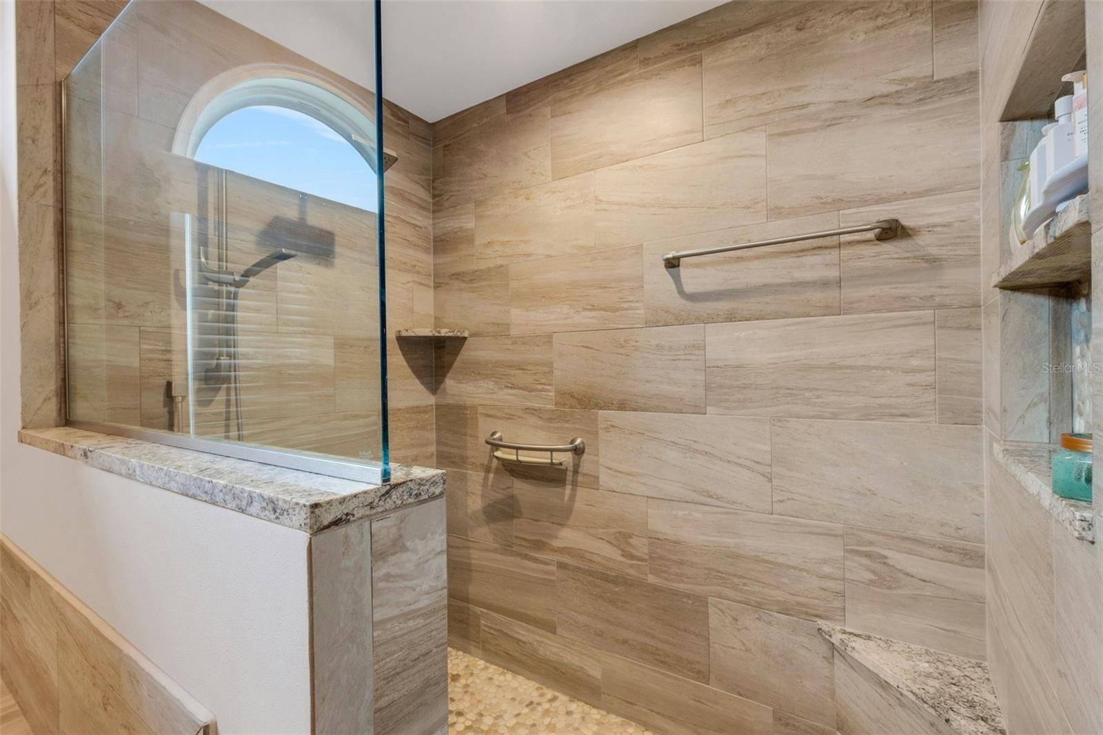 Separate shower with natural stone floor