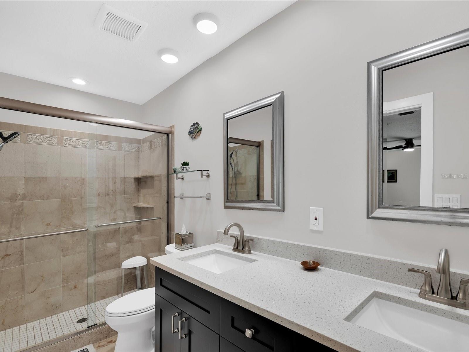 Beautifully updated en-suite bathroom w/ double vanity & large shower w/ new glass doors