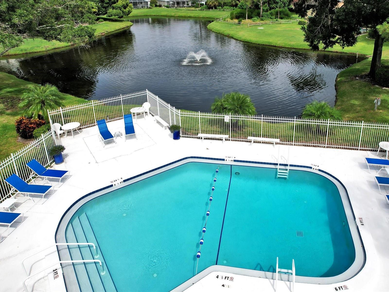 Community pool overlooks serene pond