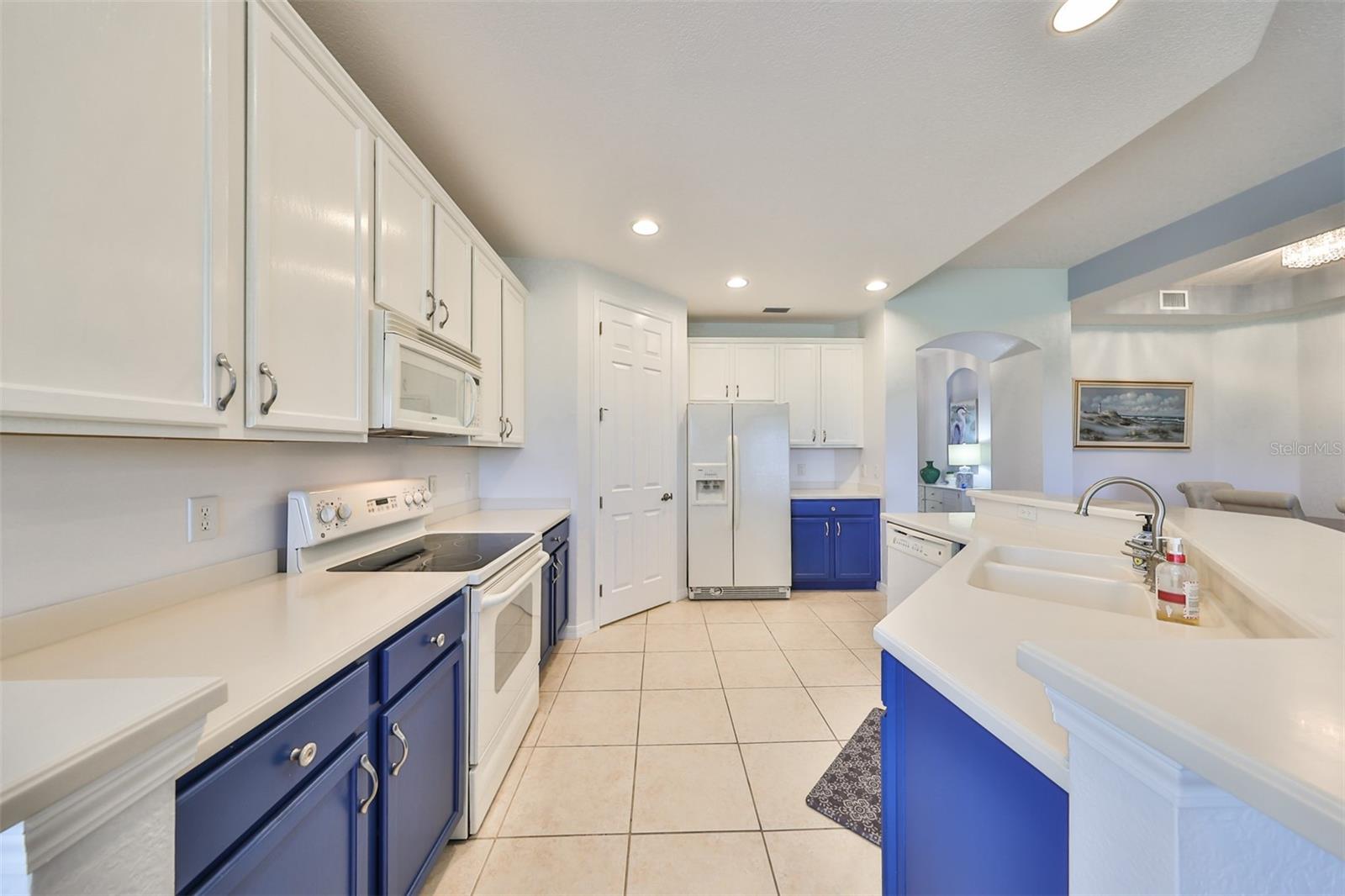 Tons of 42" all wood cabinets match perfectly with the tile flooring.