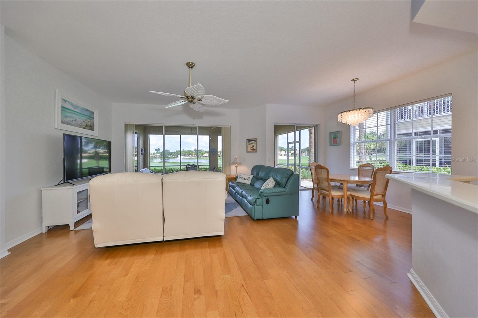 The lovely neutral tones and large windows which allow the Florida sunshine to pour in, really make this an enjoyable space.  Notice the water and clubhouse in the distance.