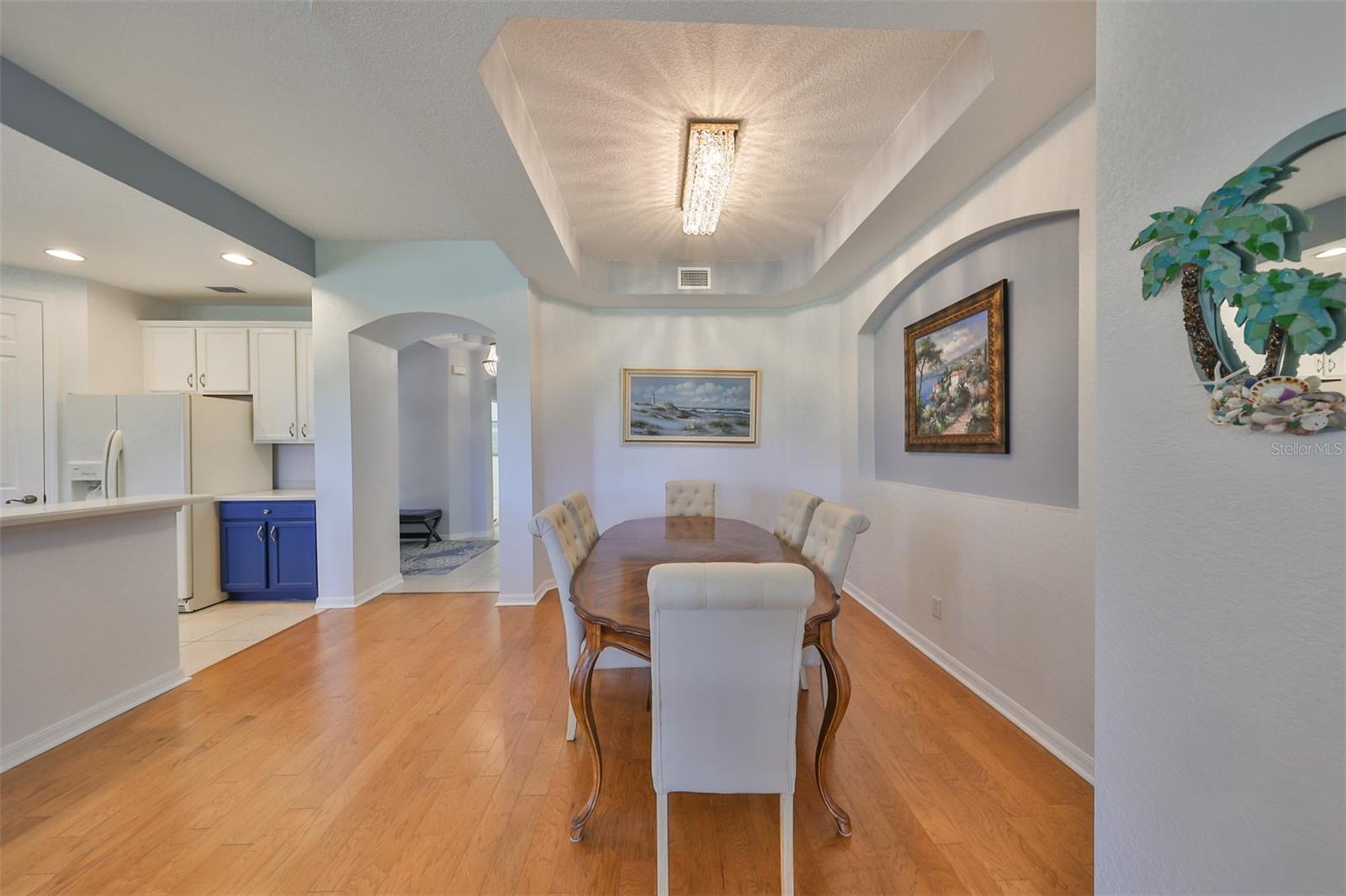 Notice the stunning light fixture in this space.  Extra arches and Architectural tray ceilings highlight the custom details of this home. You don't feel like you are in a condo at all.