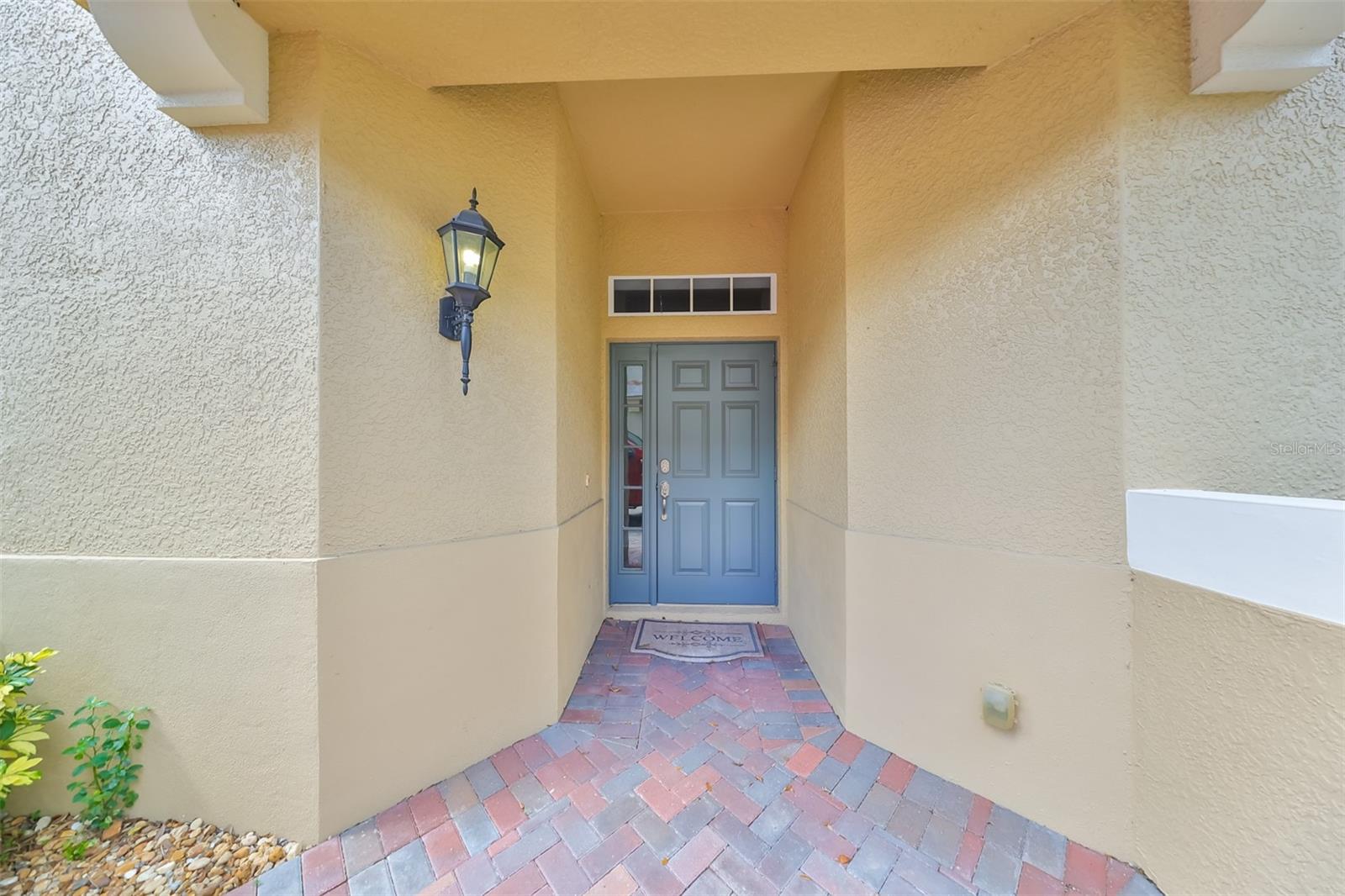 Walking up to this elegant Mediterranean resort style front entrance, you immediately feel the presence of lush tropical greenery that is beautifully landscaped