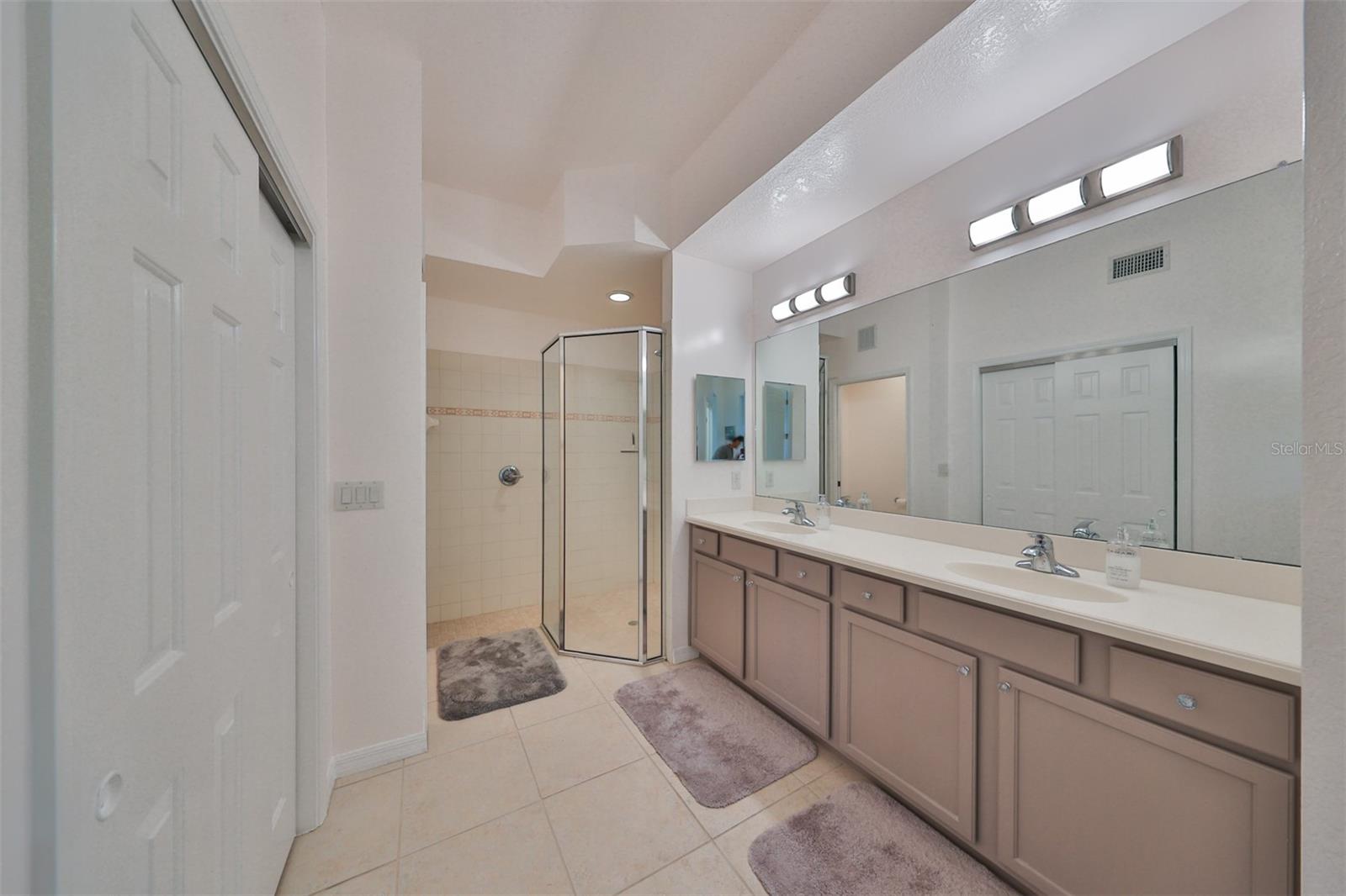 The ensuite bathroom boasts of Corian counters, dual sinks, a modern glass shower, a secondary closet, a linen closet and a private water closet.