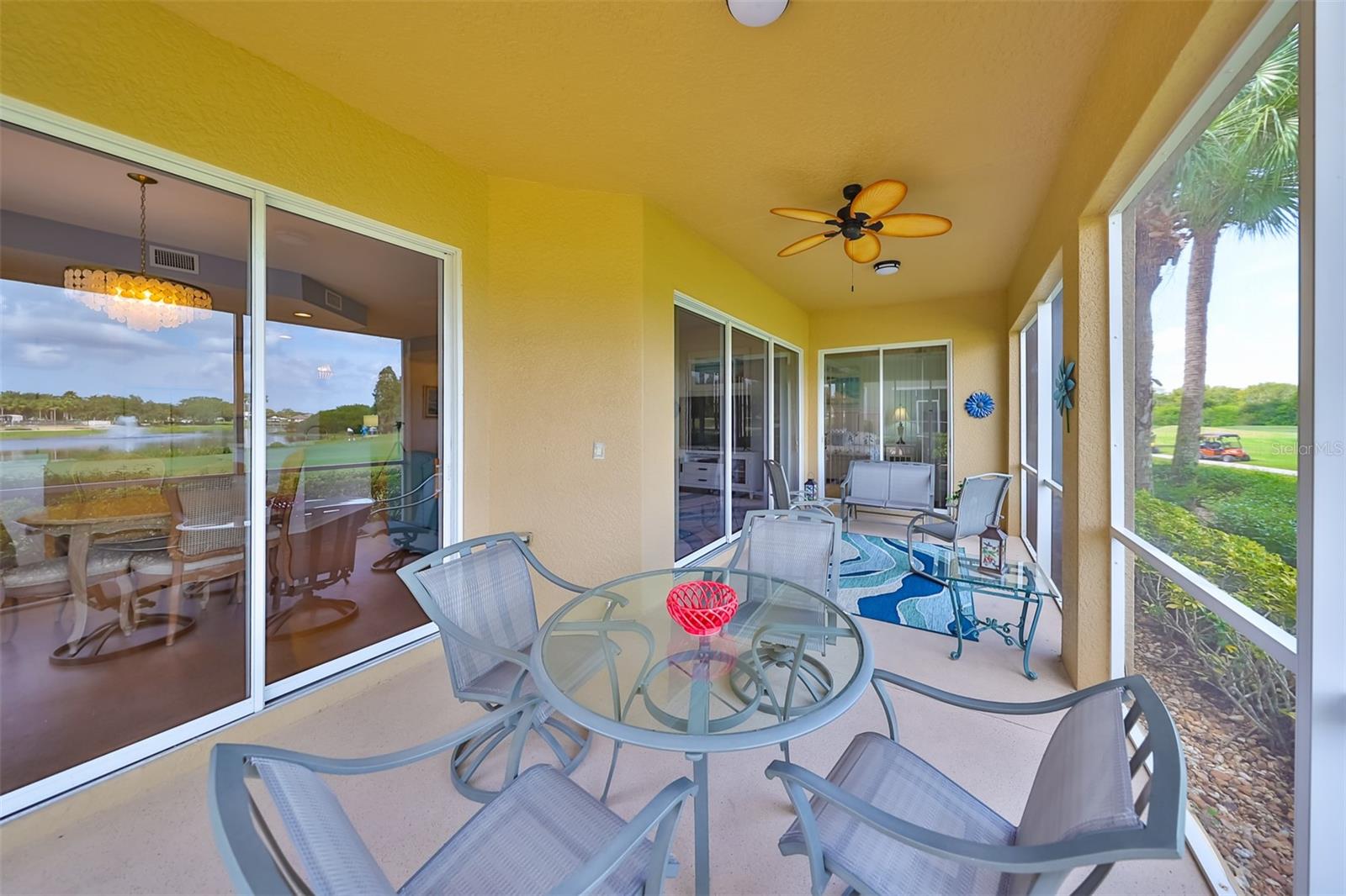 Another view of the large outdoor screened lanai with ceiling fan for extra comfort all year round