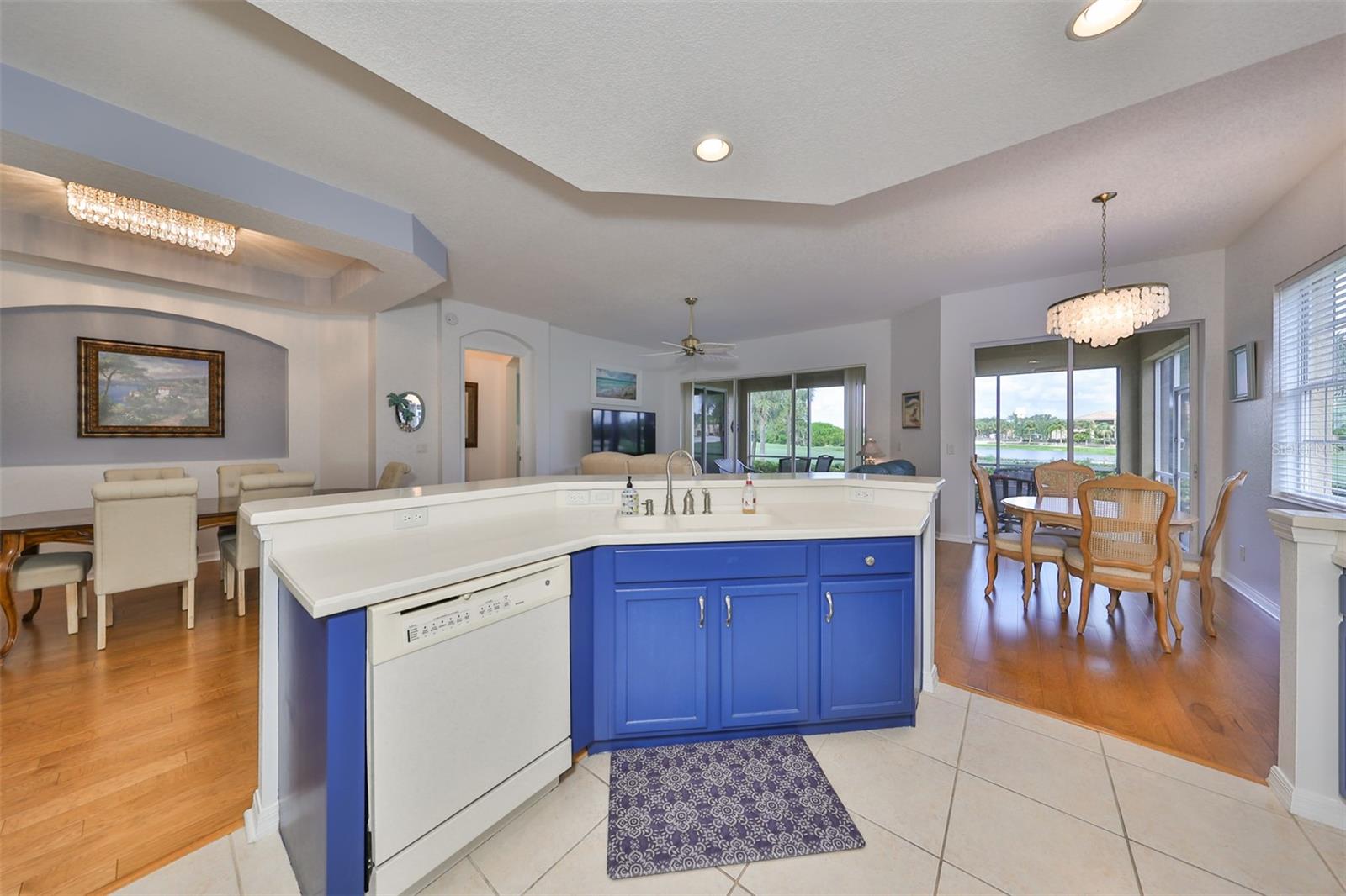 Kitchen has tile flooring with an extra island bar that includes the dishwasher and sink and extra seating/eating area.