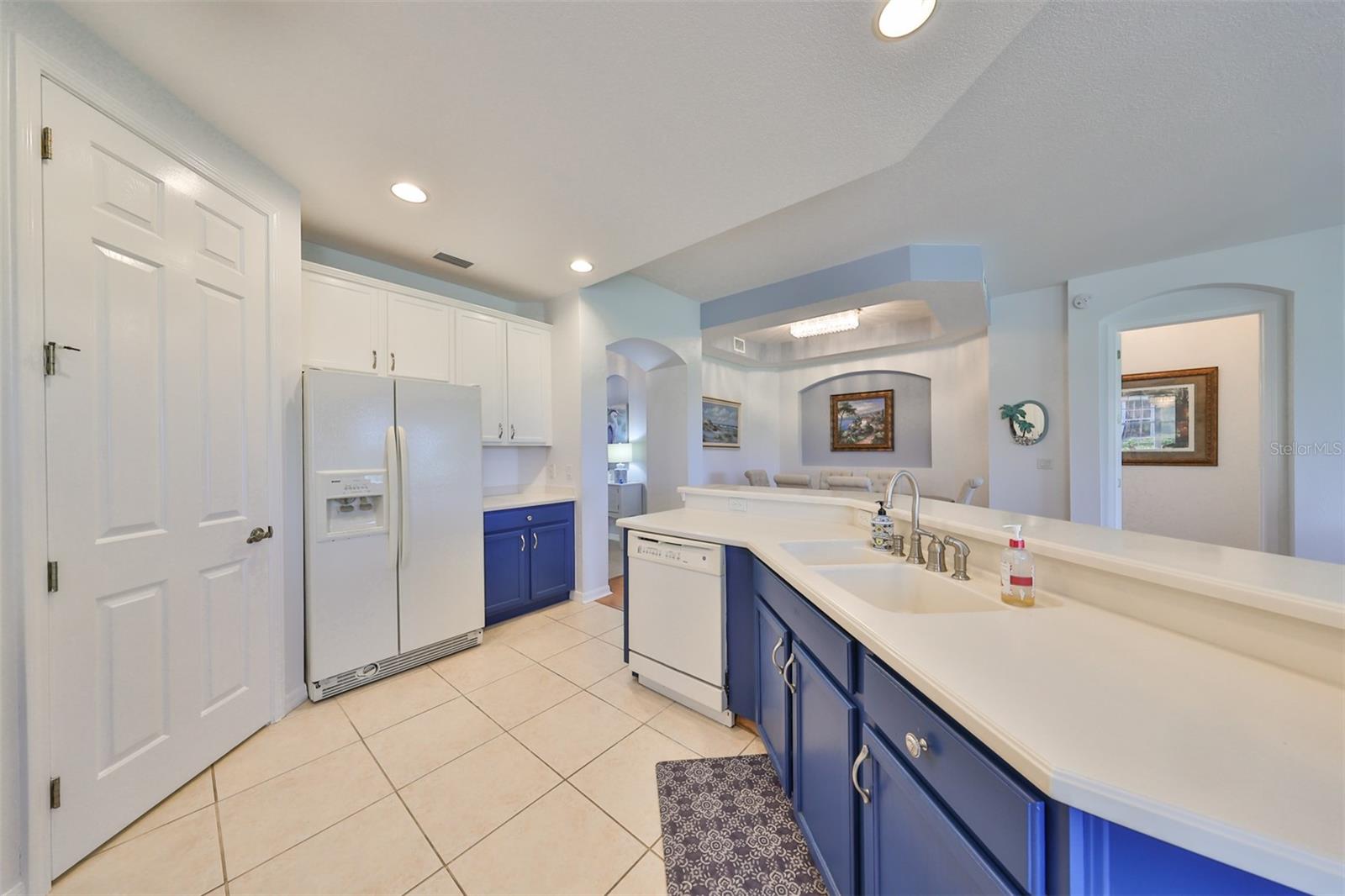 The kitchen has a large walk in pantry. Matching appliances and coastal colors, give this space a real Florida feel.