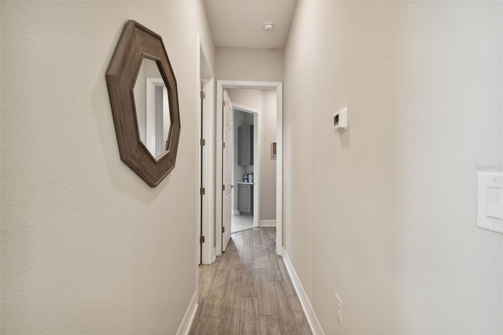 HALLWAY LEADING TO PRIMARY BED & BATH