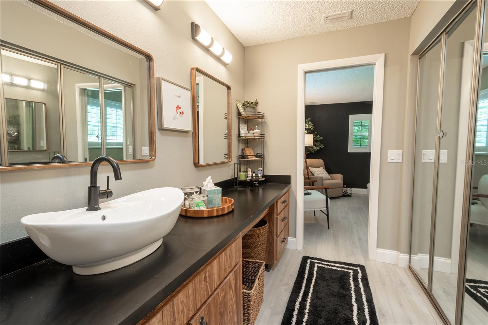 The primary bath features a new countertop, vessel sink and faucet.