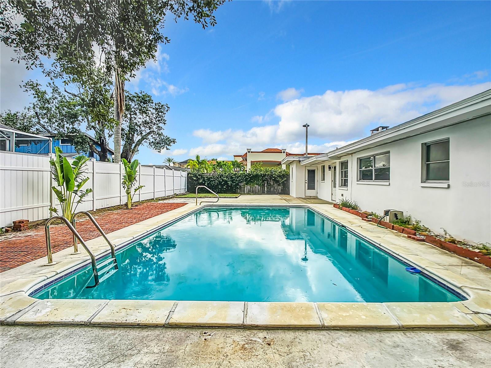 Steps out back door to privacy fenced pool