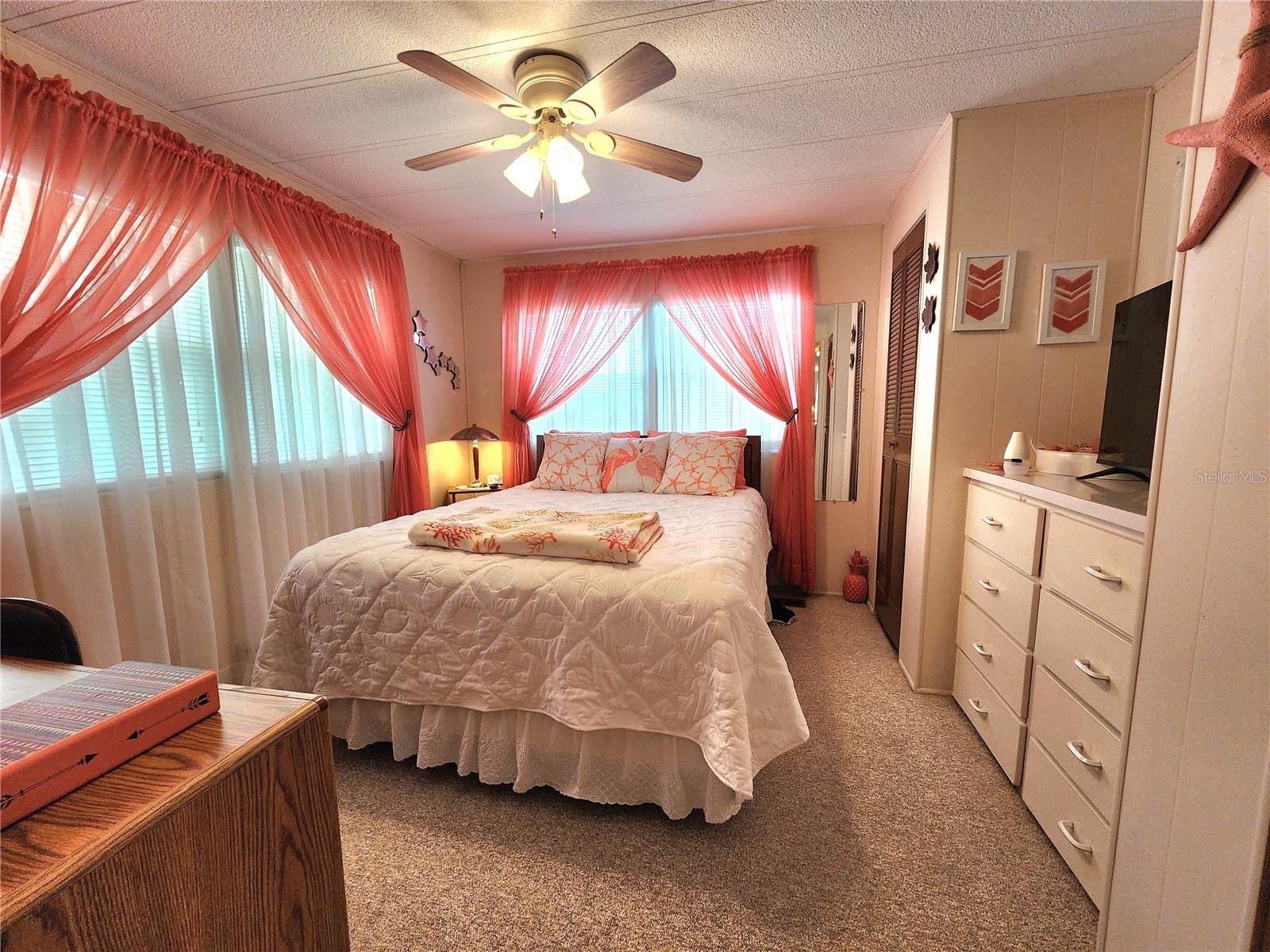 Primary bedroom with built-in dresser.