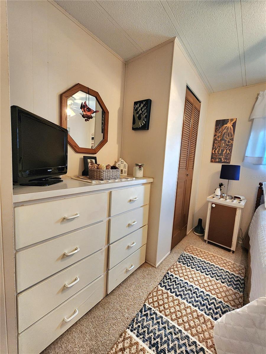 Guest bedroom with built-in dresser.