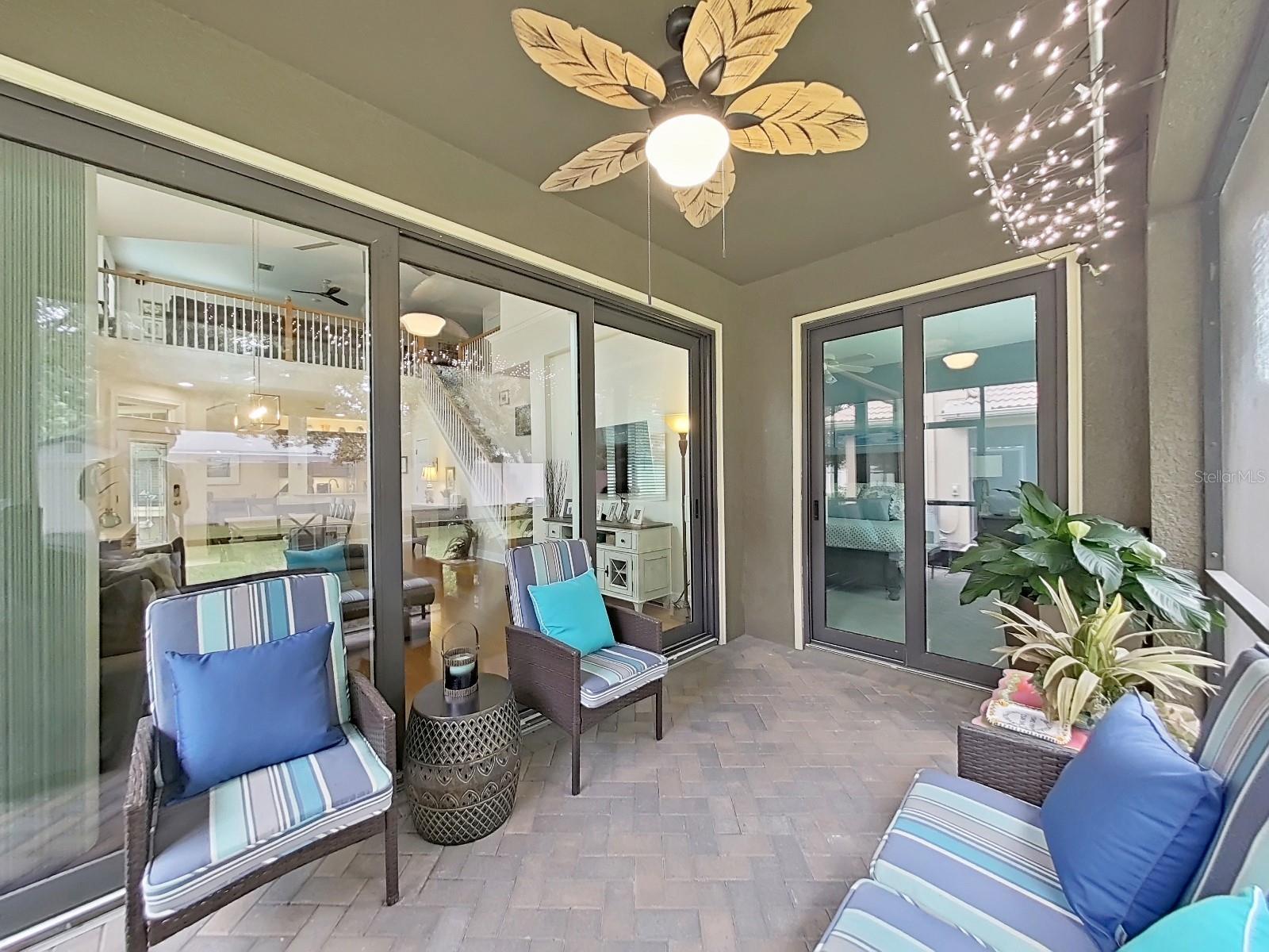 Screened in porch has pavers.