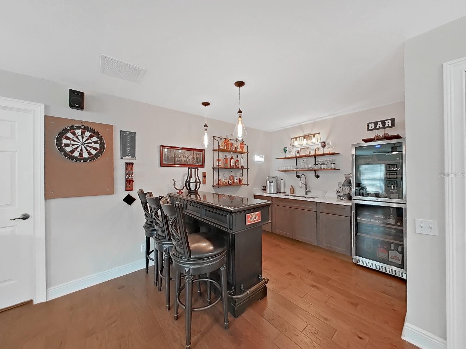 Cabinet and sink, shelving for glassware and bottles and best of all- glass front wine cooler and refrigeration system.  Lots of storage and drawers in bar as well.