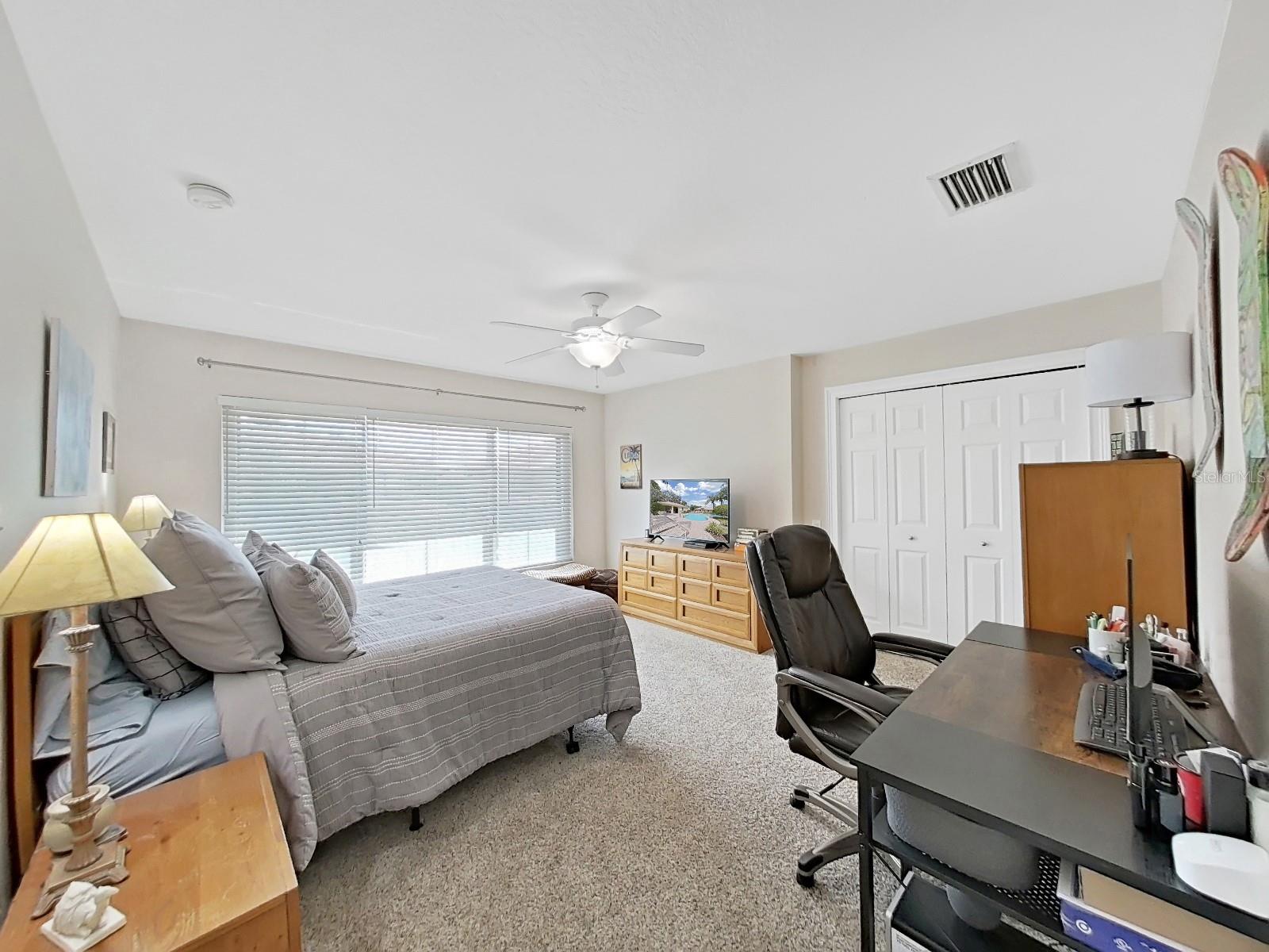 2nd bedroom off loft has wall of windows for more natural light.