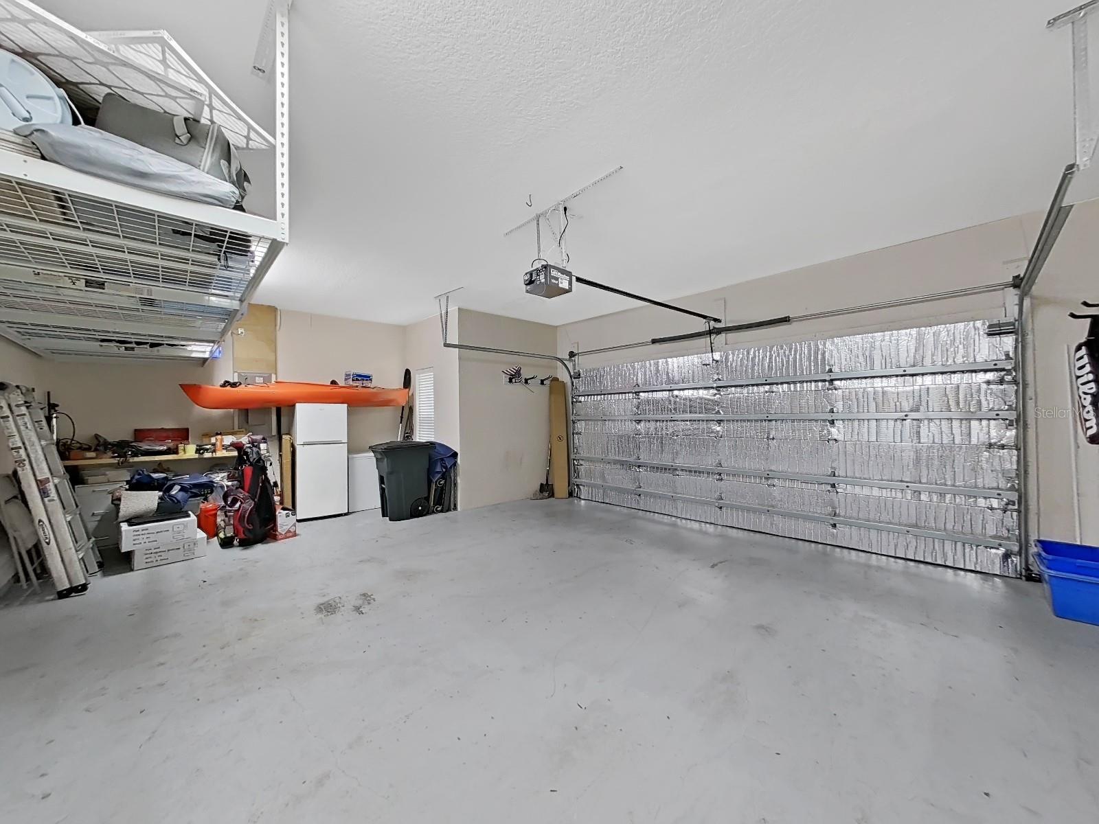 Oversized 2 car garage with overhead storage. Garage door has extra insulation to keep cooler