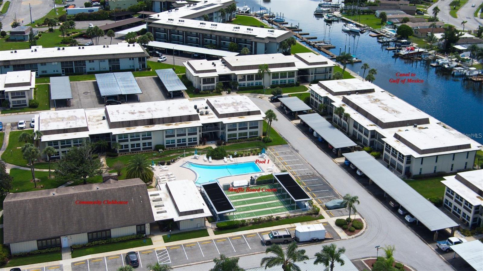 Main Clubhouse, Heated Pool, Shuffleboard courts and canal leading to the Gulf of Mexico