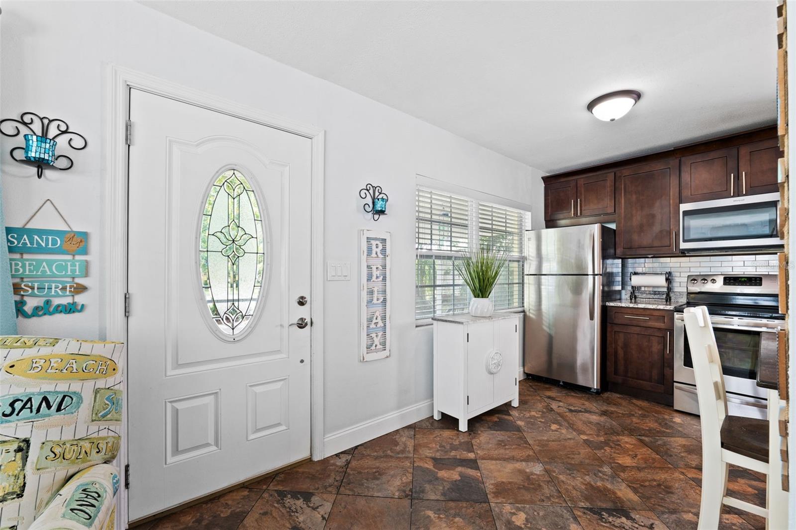 Front door plus glass storm door to allow a great view out to the front shady lawn