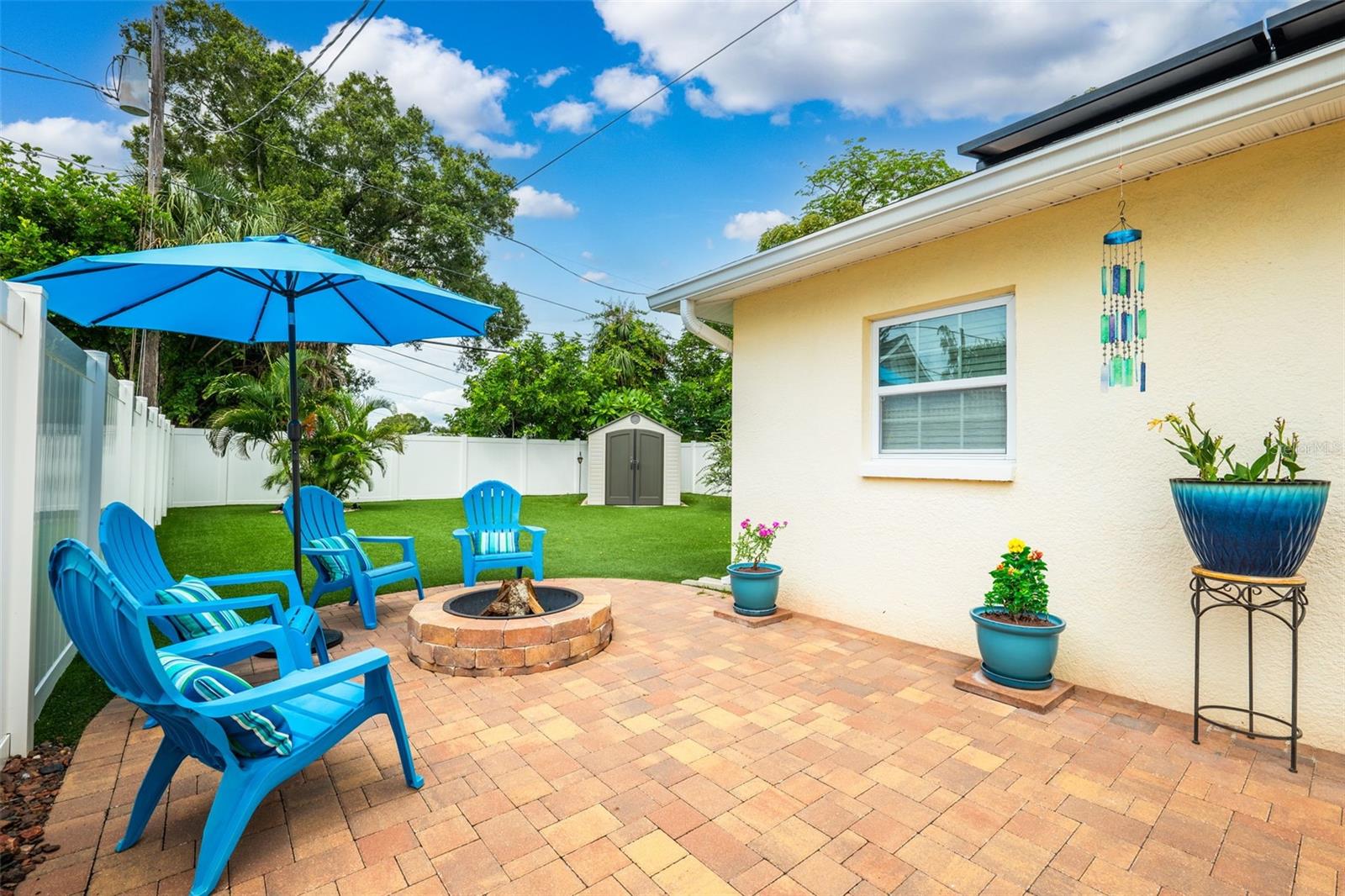 Spacious paver patio with fire pit and plenty of space to entertain.