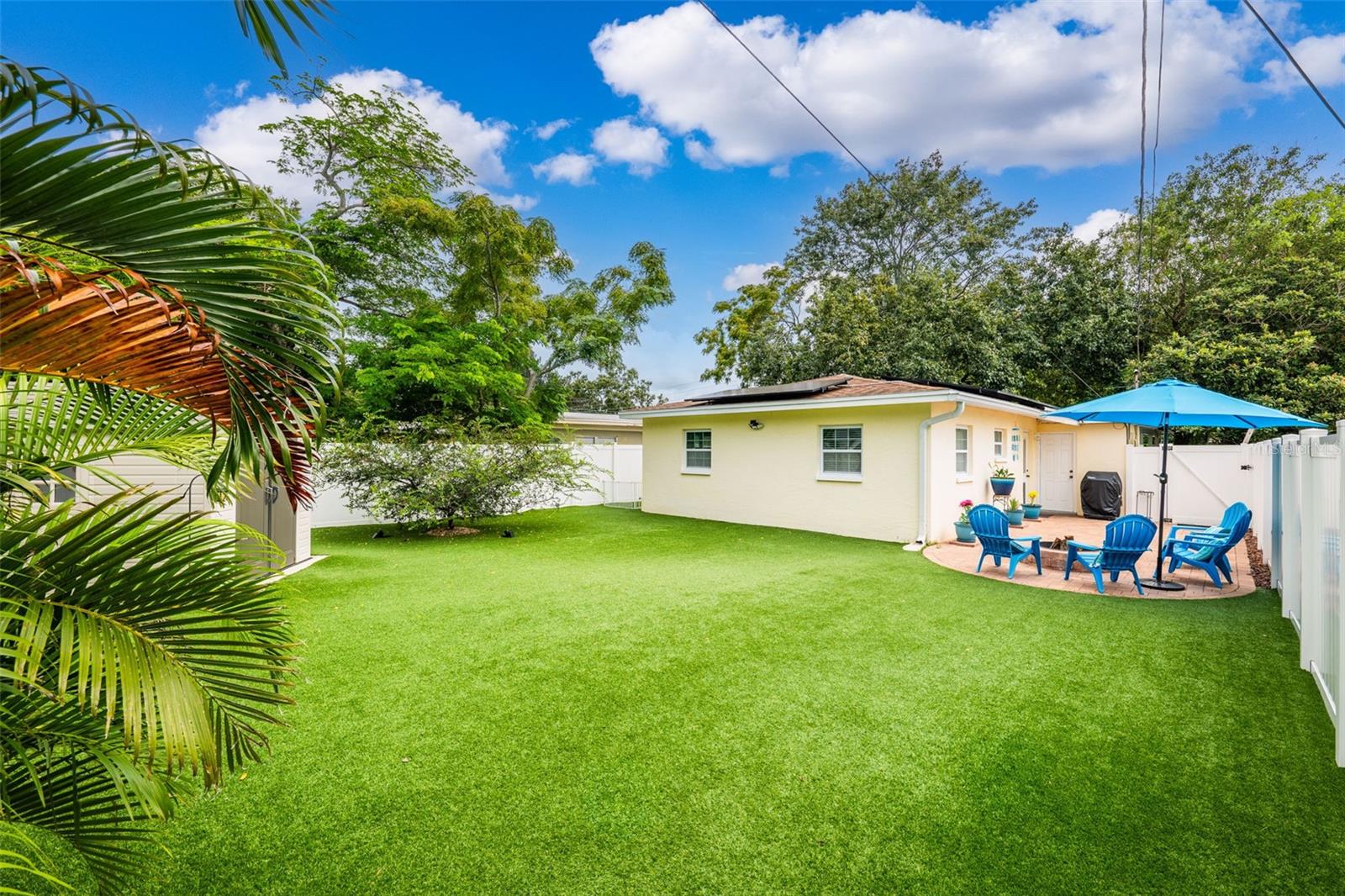 Pet-friendly turf, vinyl privacy fence, and storage shed make for a well-equipped rear lawn.