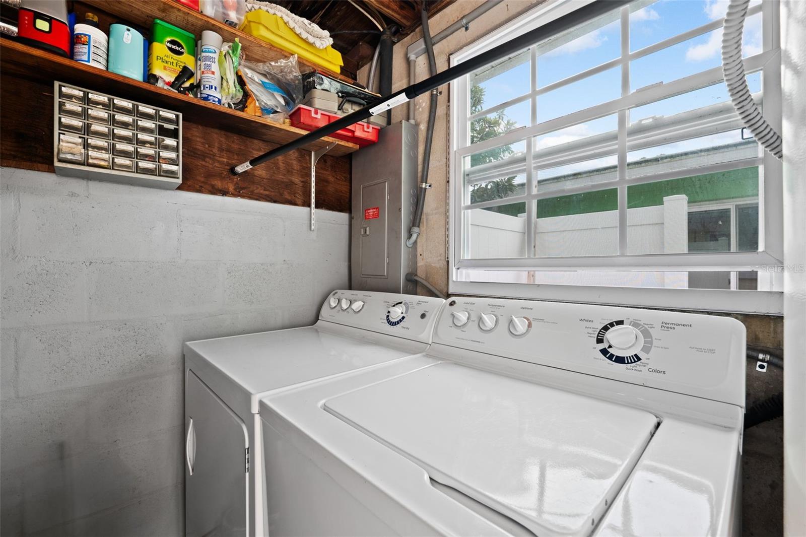 Laundry room with storage space just outside the kitchen.