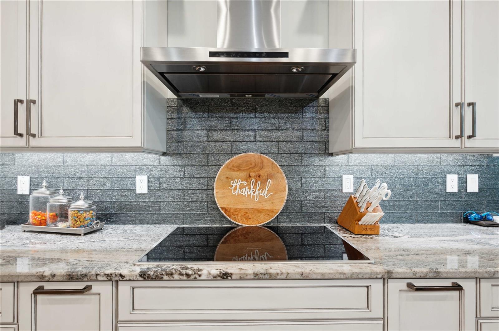 Custom Kitchen with glass backsplash