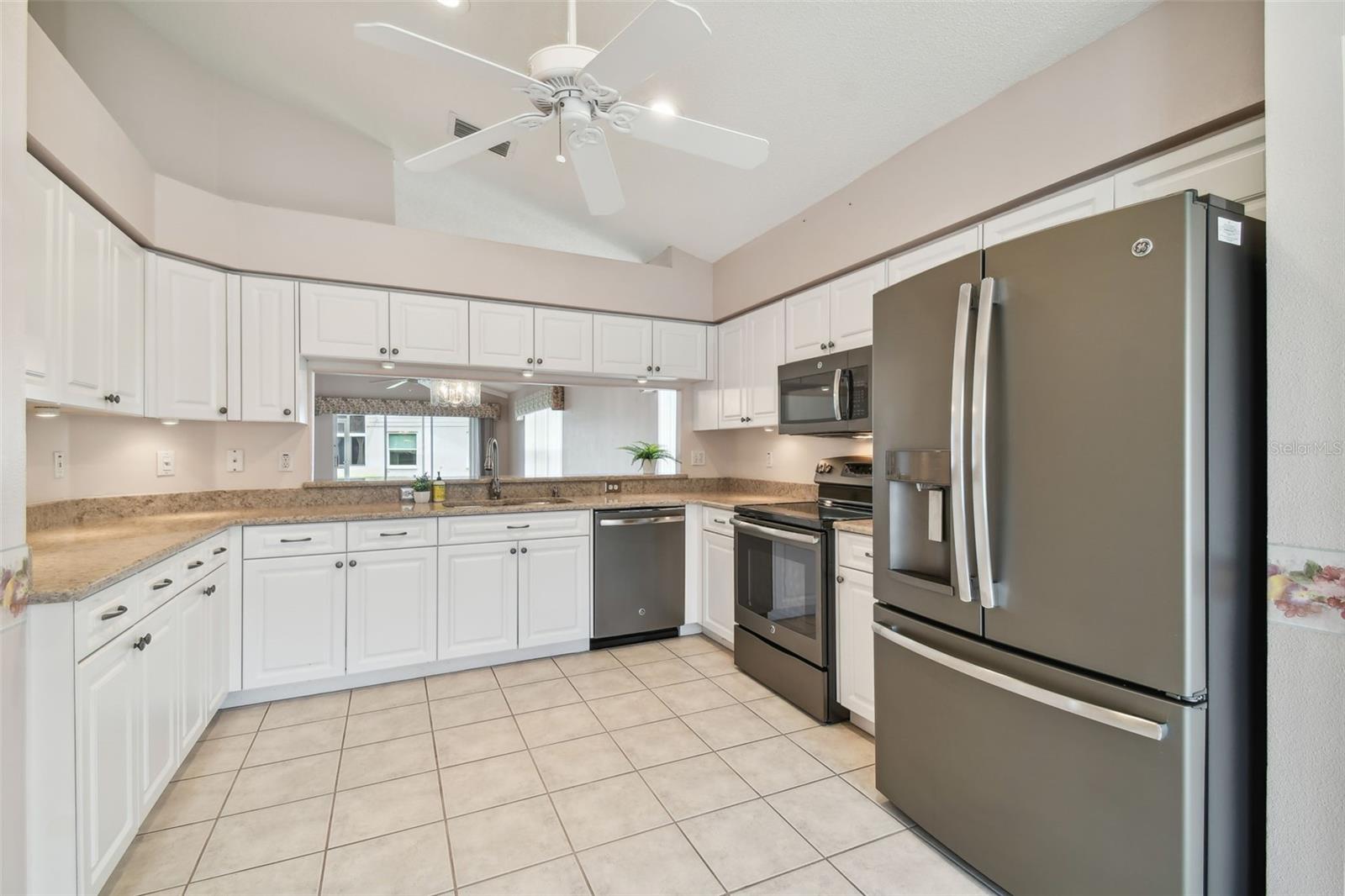 stainless steel appliance package quartz counter tops. under the cabinets lighting. Eat in kitchen with a bay window.