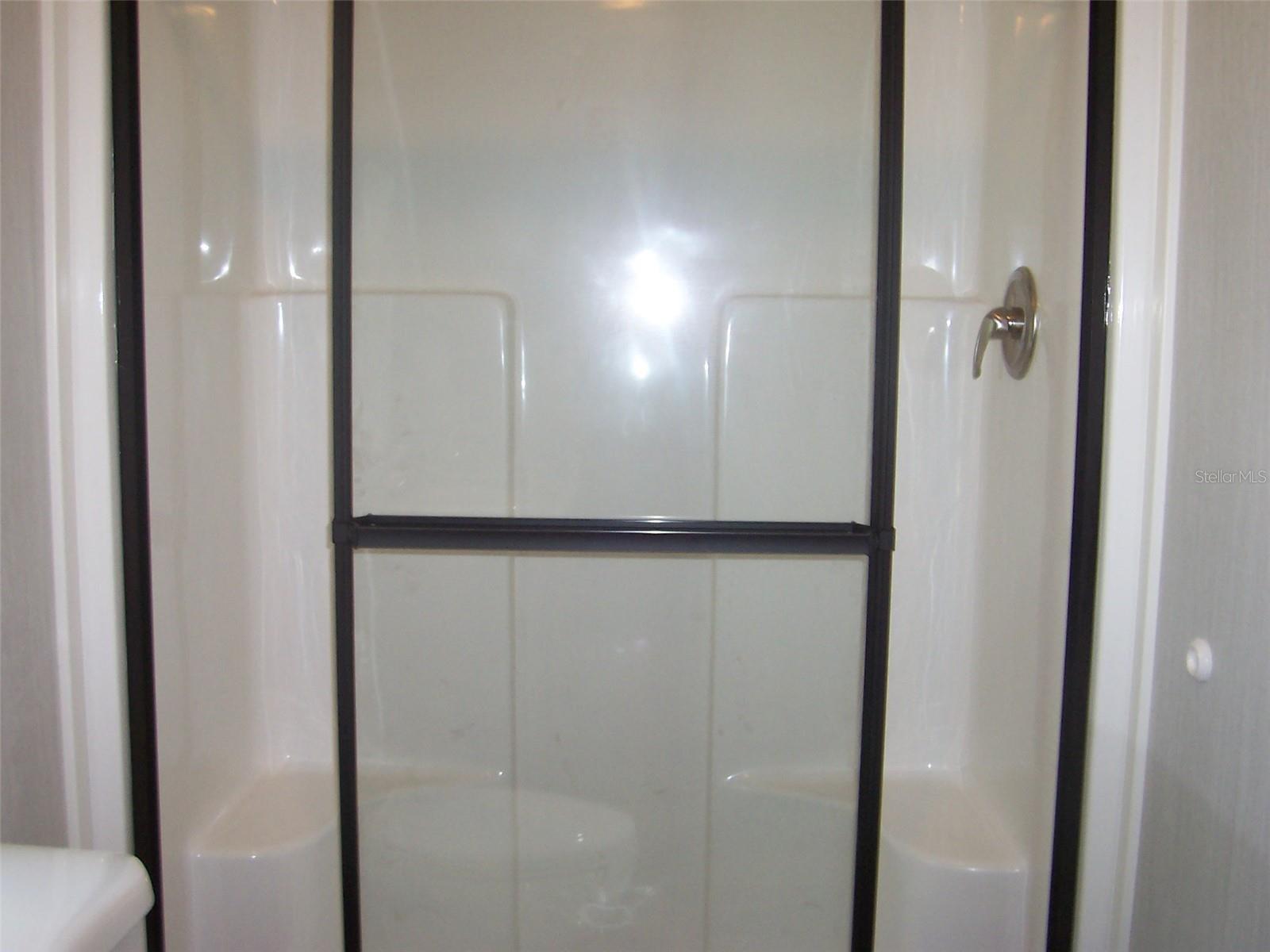 Beautiful owners bath with seats in the walk in shower!