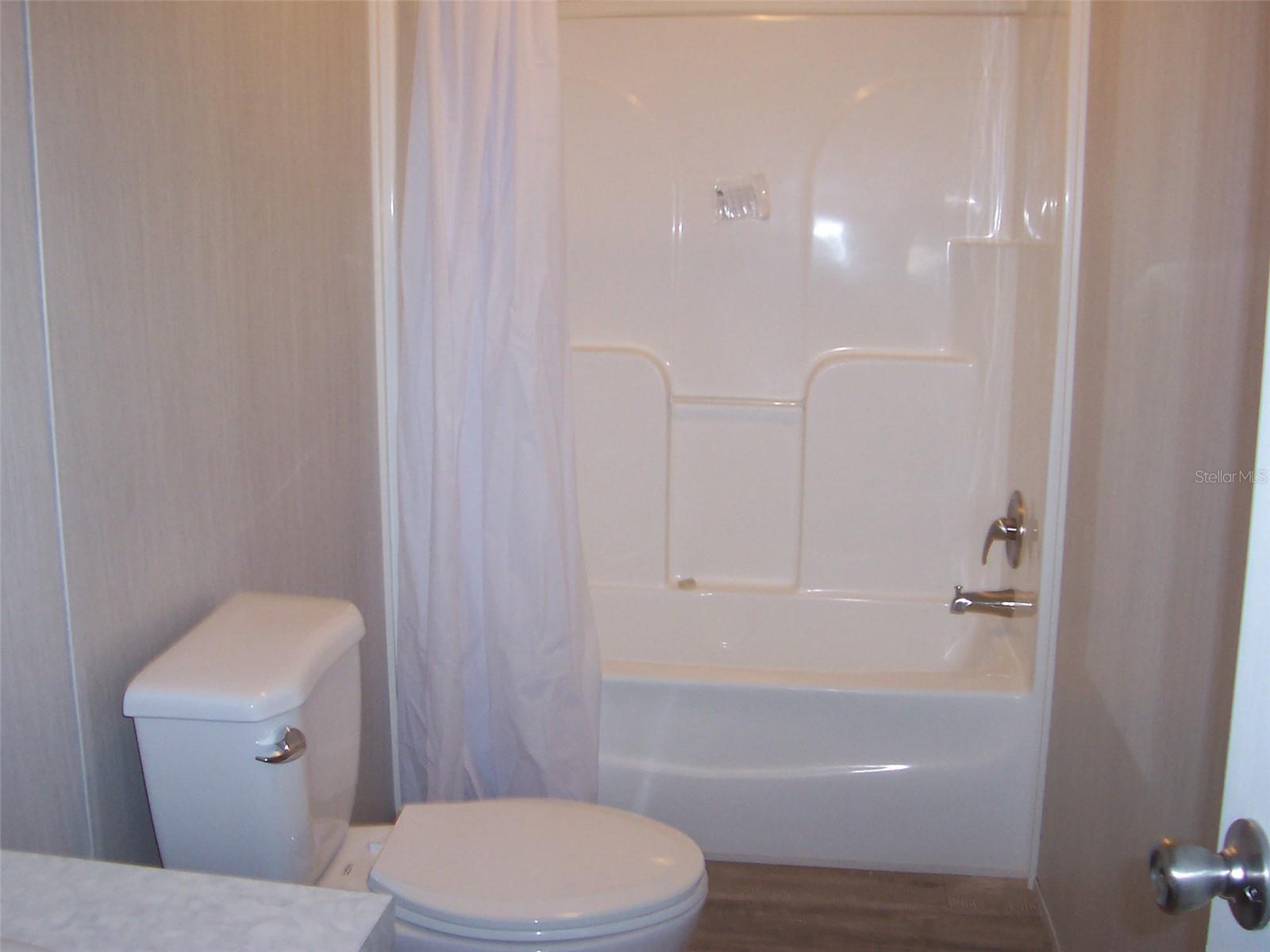 Guest bath with shower tub combination between 2nd and 3rd bedrooms.