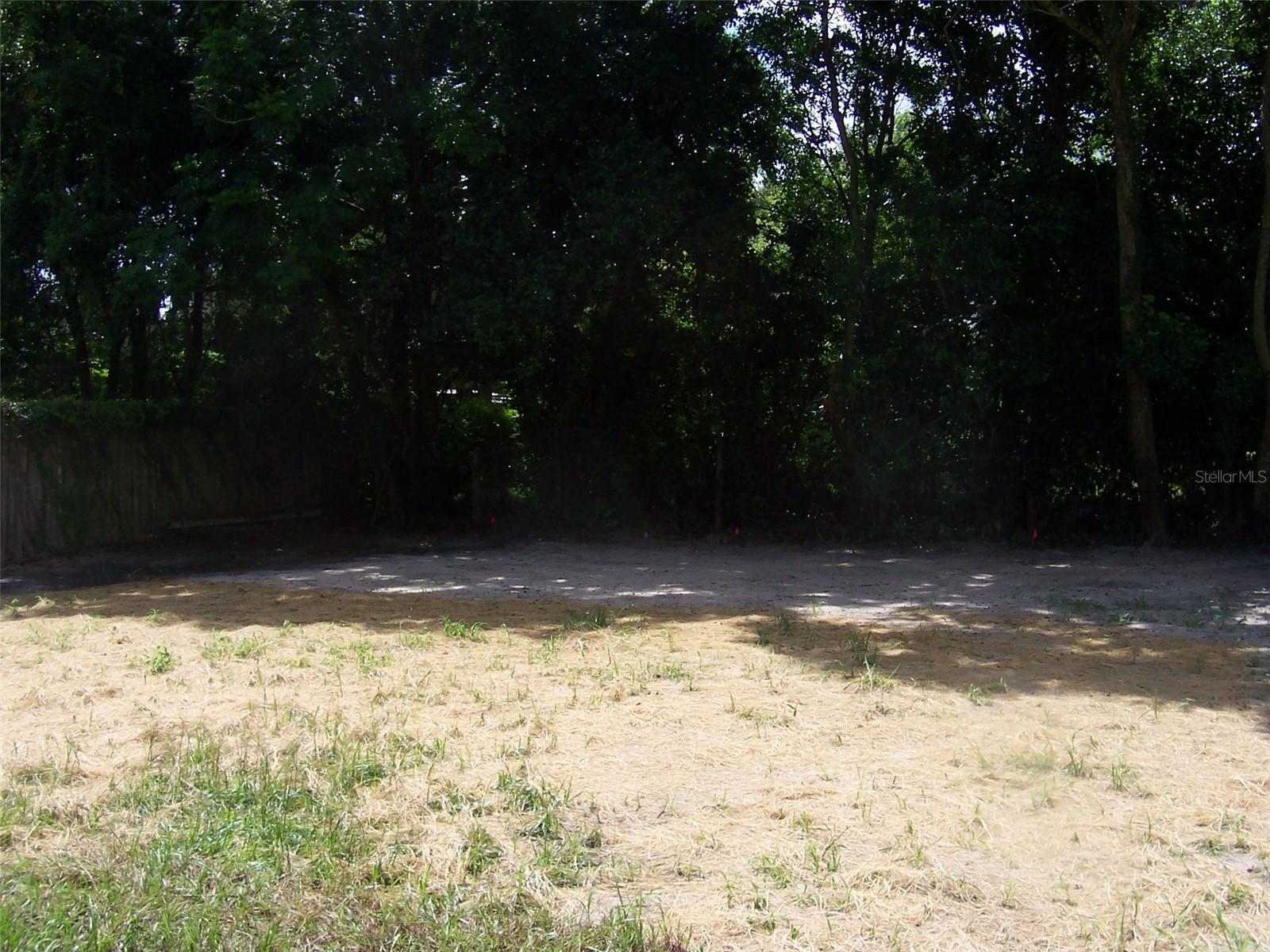 Back yard has been recently freshly seeded with grass.  The woods provide great privacy.