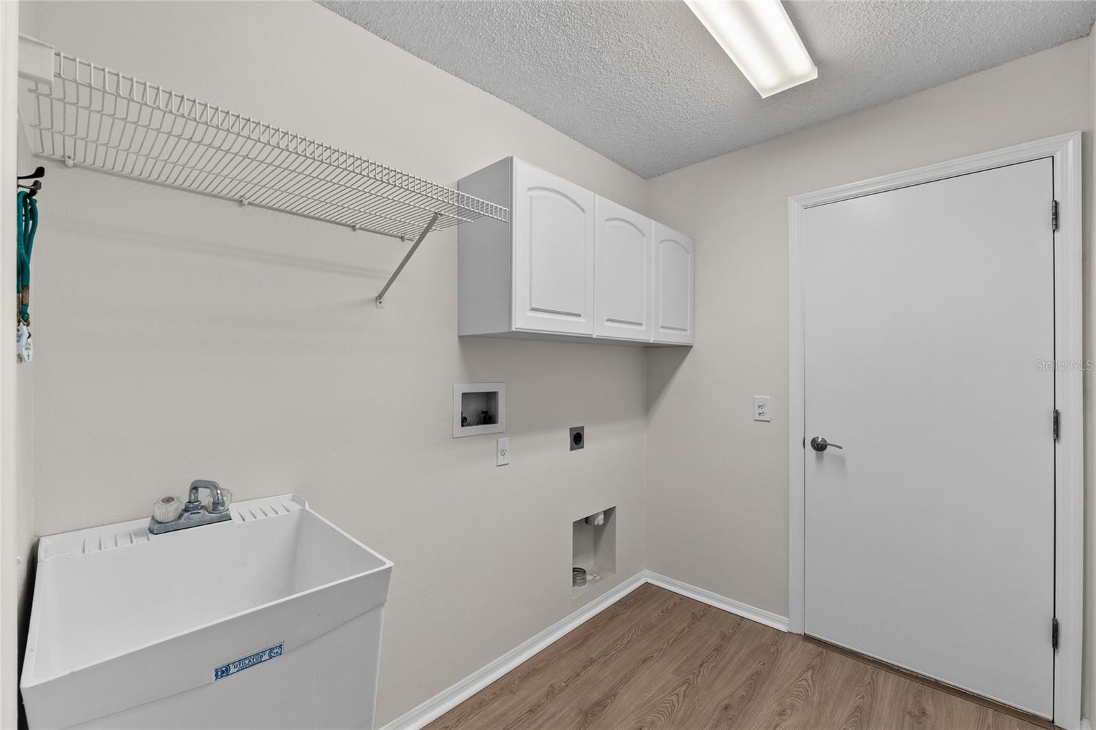 Separate Laundry Room with Utility Sink & Storage