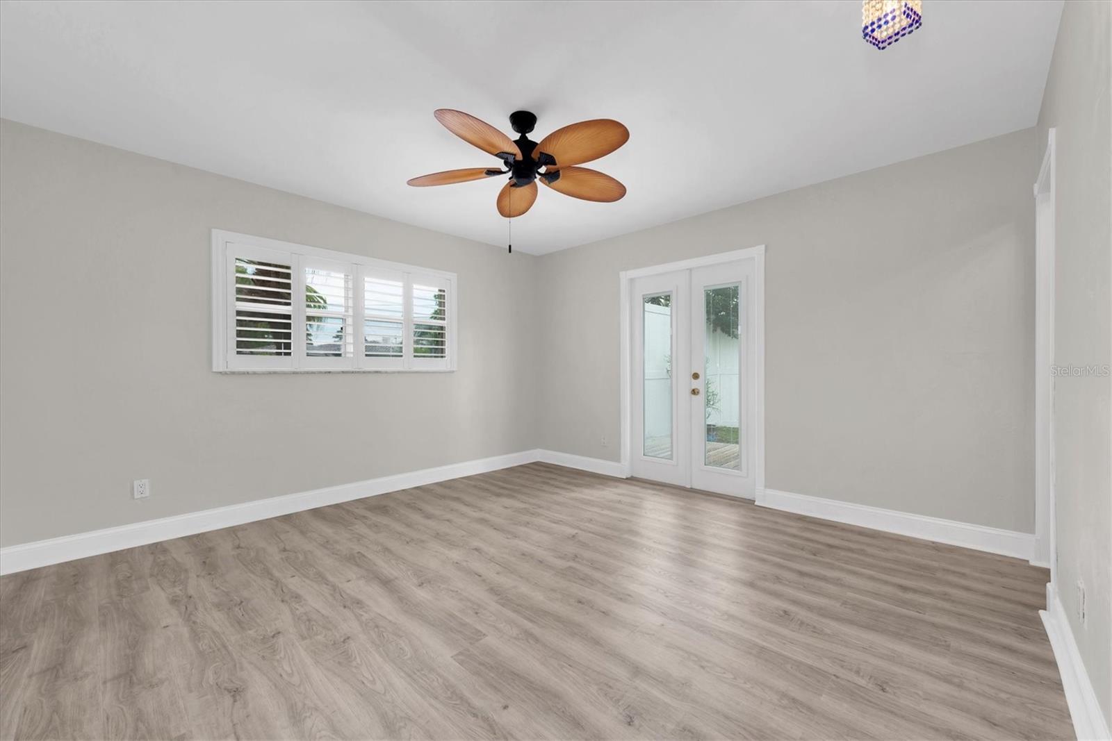 Main bedroom with French doors leading to private patio