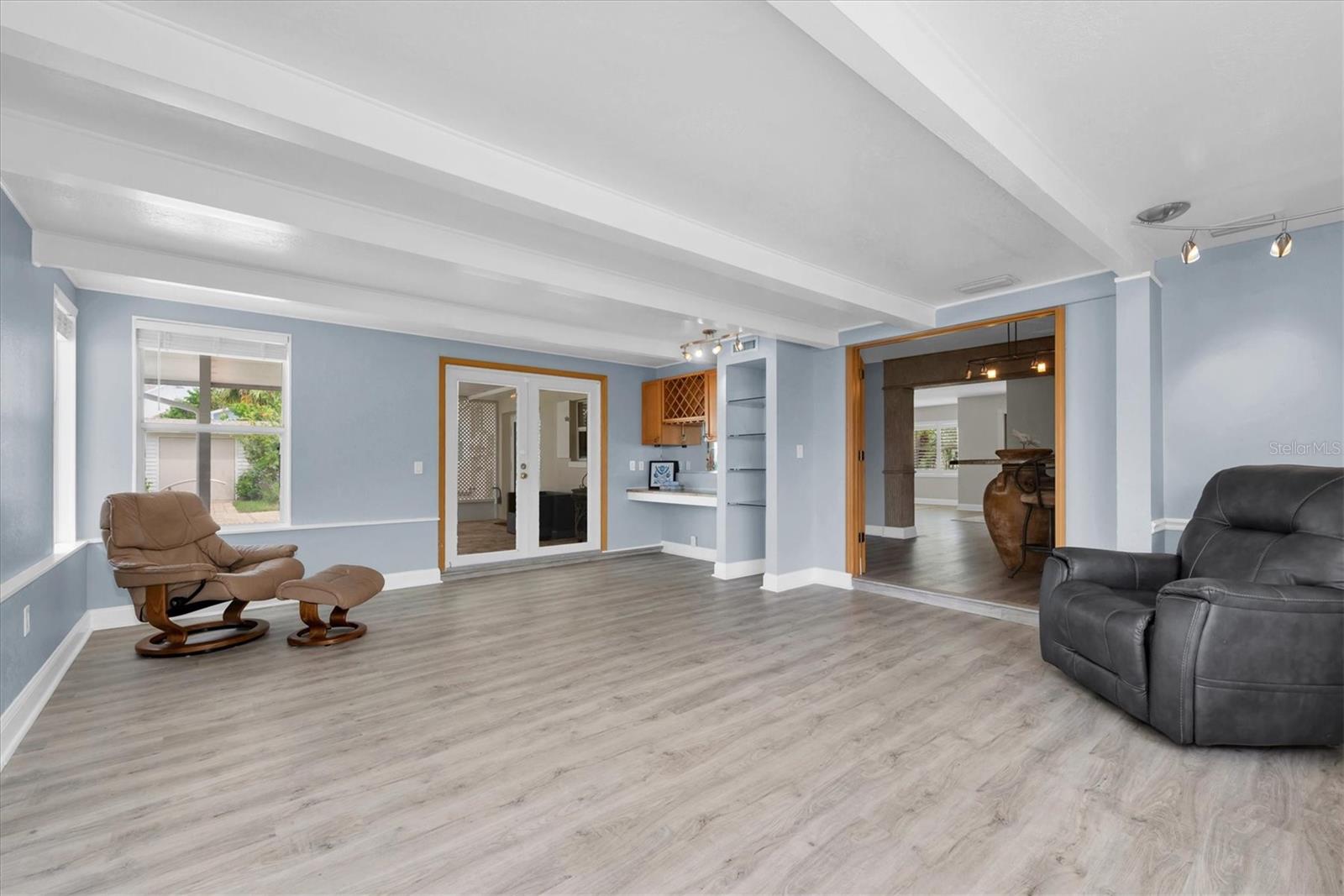 Media Room with French doors leading out to  the backyard and the pool area