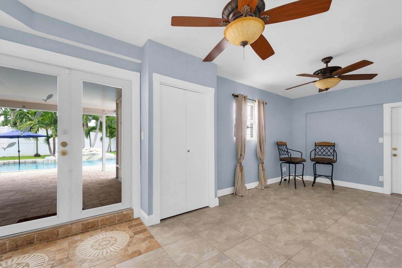 Bonus room with French doors leading to the covered patio and salt water pool